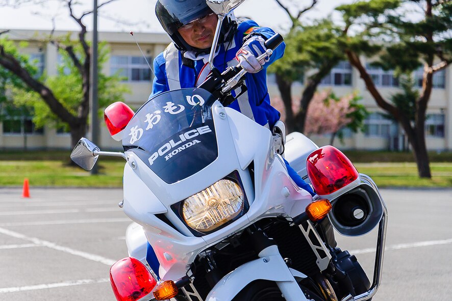 Local community Police Officer Sgt. Mikami Kazutaka takes part in a motorcycle demonstration at Misawa Air Base, Japan, May 14, 2014. The 35th Security Forces Squadron worked together with local police officers and Japan Self-Defense Forces security members to host events in commemoration of National Police Week. (U.S. Air Force photo/Staff Sgt. Jared Elliott)