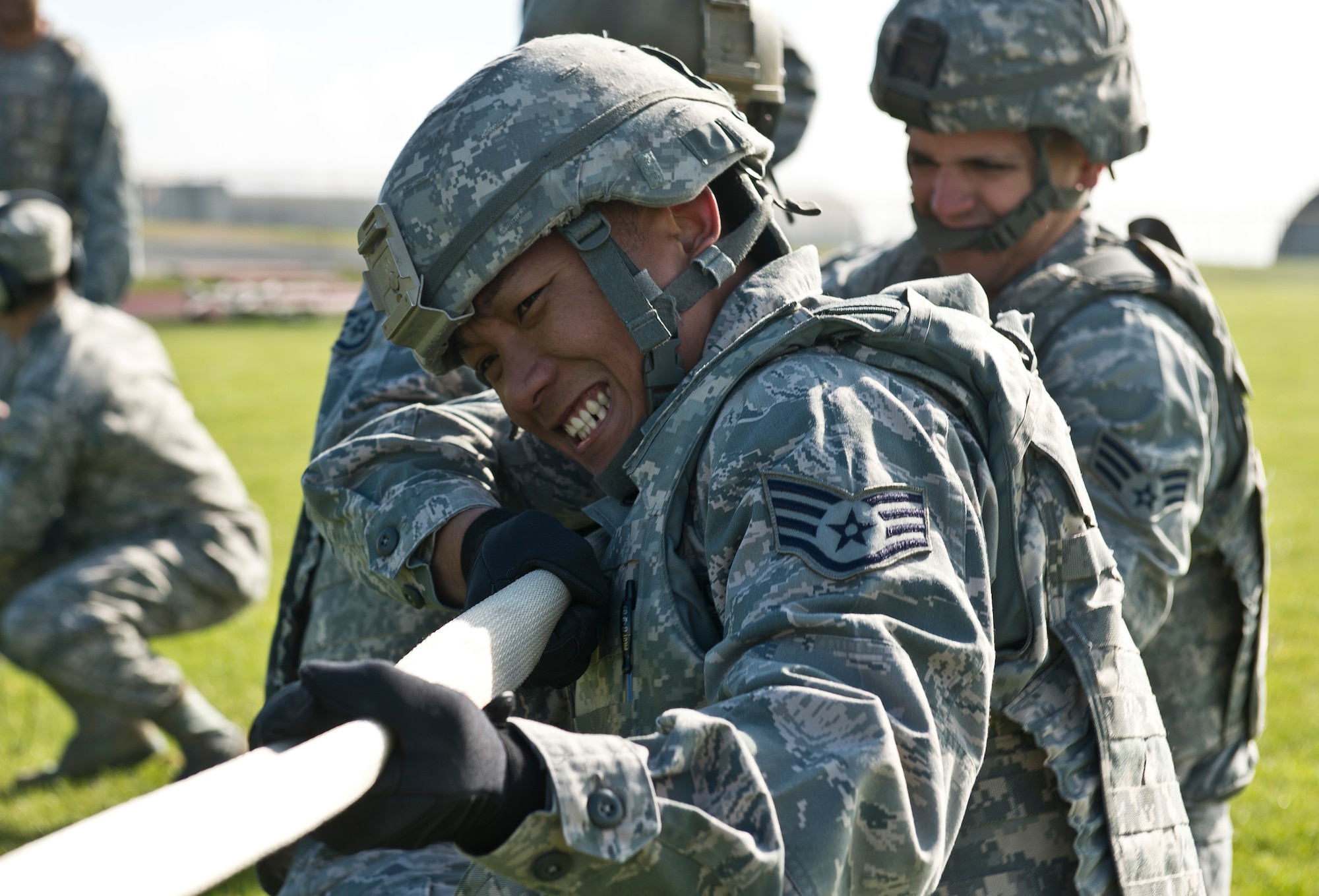 U.S. Air Force Staff Sgt. Julious Del Rosario, 52nd Security Forces Squadron patrolman, competes in a tug-of-war match during the 52nd SFS National Police Week decathlon at Spangdahlem Air Base, Germany, May 14, 2014. The tug-of-war was the first of 10 stations spread out along a 3.5 mile course, ending with a timed tactical scenario where Airmen cleared a house with simulated ammunition. The winning team was from the 52nd SFS police services section. (U.S. Air Force photo by Staff Sgt. Chad Warren/Released)