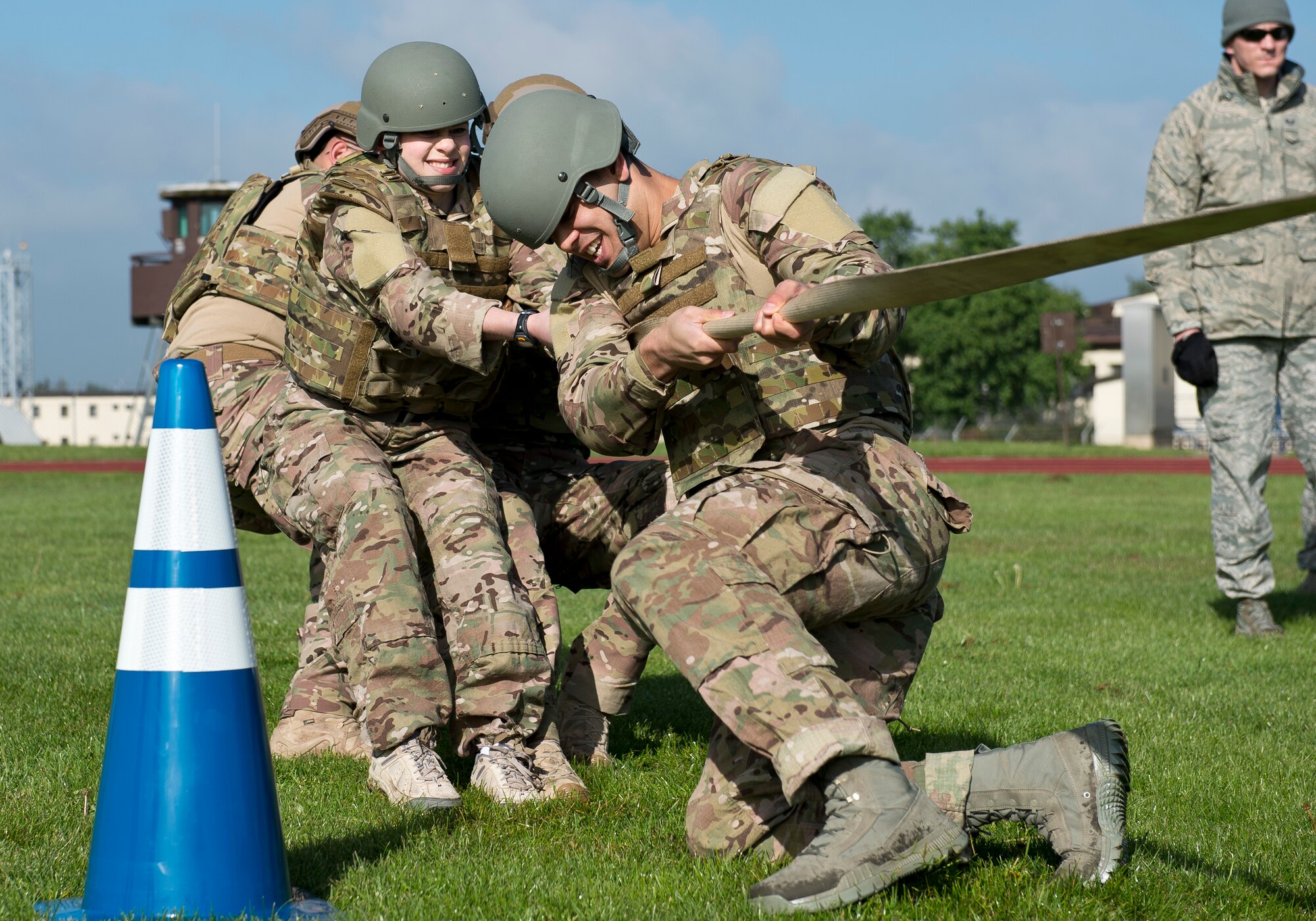 Participants compete in a tug-of-war match during the 52nd Security Forces Squadron National Police Week decathlon at Spangdahlem Air Base, Germany, May 14, 2014. The event consisted of 10 stations spread out along a 3.5 mile course, including team push-ups, a litter carry and low crawling through the mud. The winning team was from the 52nd SFS police services section. (U.S. Air Force photo by Staff Sgt. Chad Warren/Released)
