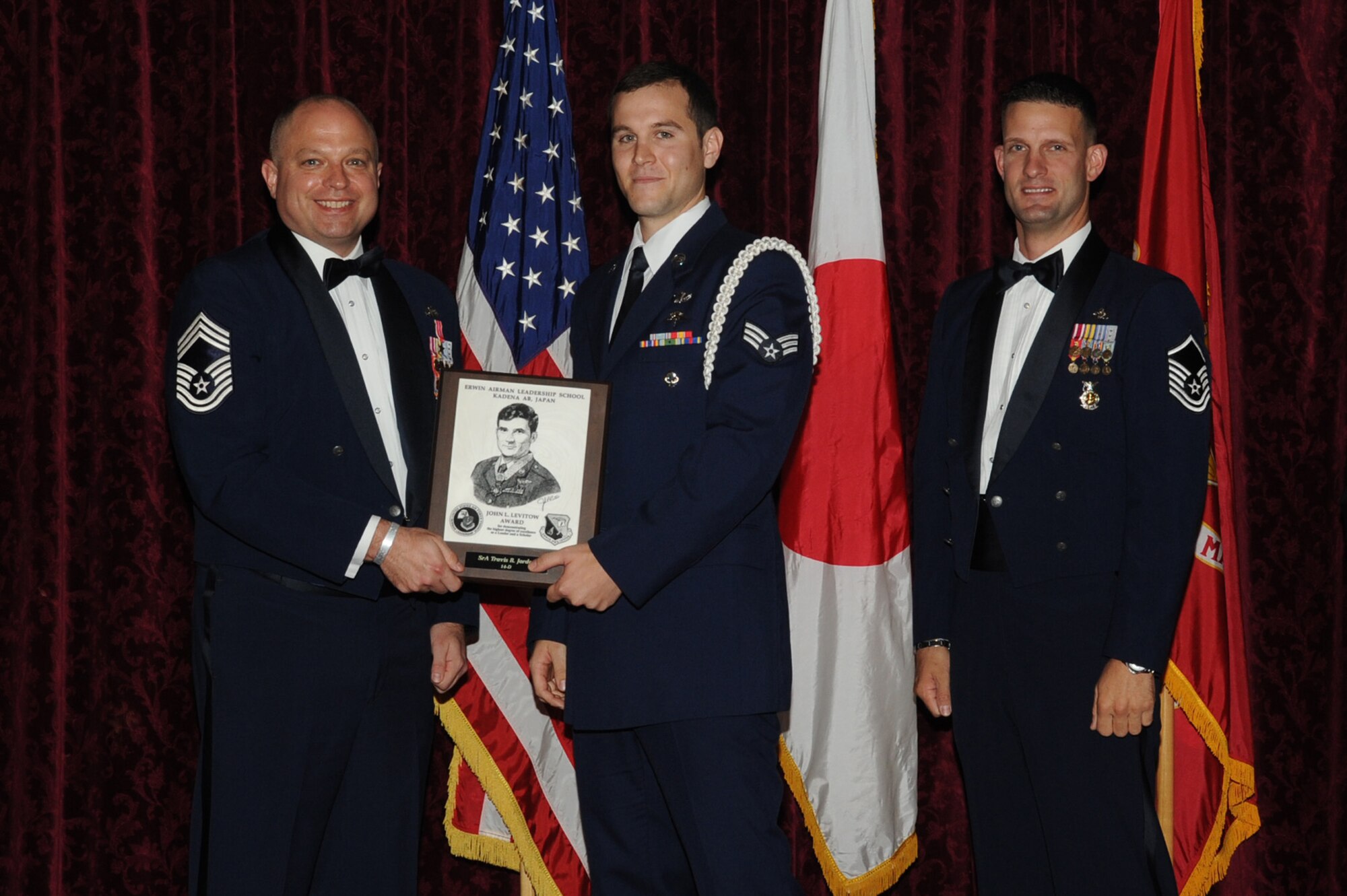 U.S. Air Force Senior Airman Travis R. Jordan, 320th Special Tactics Squadron, accepts the John L. Levitow Award during the graduation ceremony for ALS Class 14-D on Kadena Air Base, Japan, May 15, 2014. The John L. Levitow Award is presented to the student who earns the highest average score on evaluations and most embodies the Air Force core values. (U.S. Air Force photo by Airman 1st Class Zackary A. Henry)