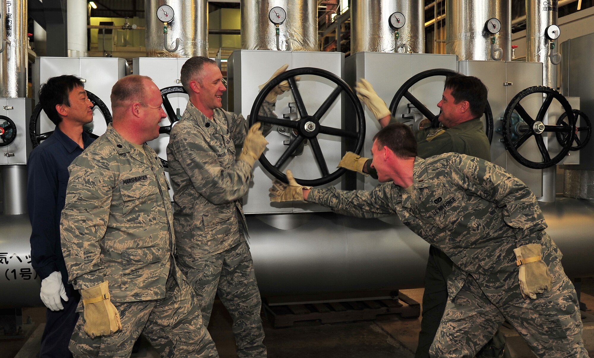 With the warm weather finally here to stay during the spring and summer days, base leadership took part in the loosening of pressure from a valve on a steam header that turned off the heat compartments in base housing at Misawa Air Base, Japan, May 16, 2014. Turning the heating systems off helps the base conserve energy and in turn save dollars. Personnel from the 35th Civil Engineer Squadron are also able to begin providing maintenance on these valves. (U.S. Air Force photo/Senior Airman Jose Hernandez-Domitilo)