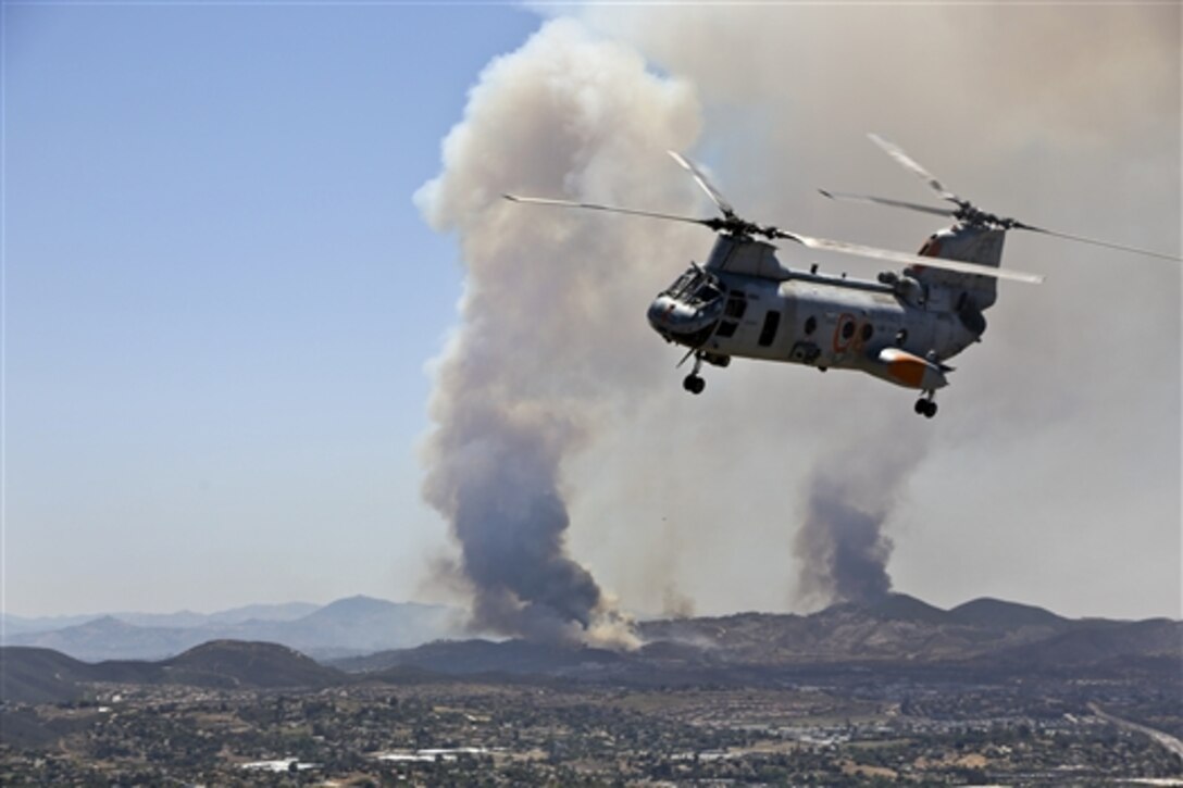U.S. Marines assist in efforts to contain Cocos fire in San Marcos, Calif., May 15, 2014. The Marines, assigned to Marine Medium Helicopter Squadron 364, Marine Aircraft Group 39, 3rd Marine Aircraft Wing, Marine Corps Base Camp Pendleton. partnered with state officials to conduct aerial firefighting against several wildfires ablaze in San Diego County.