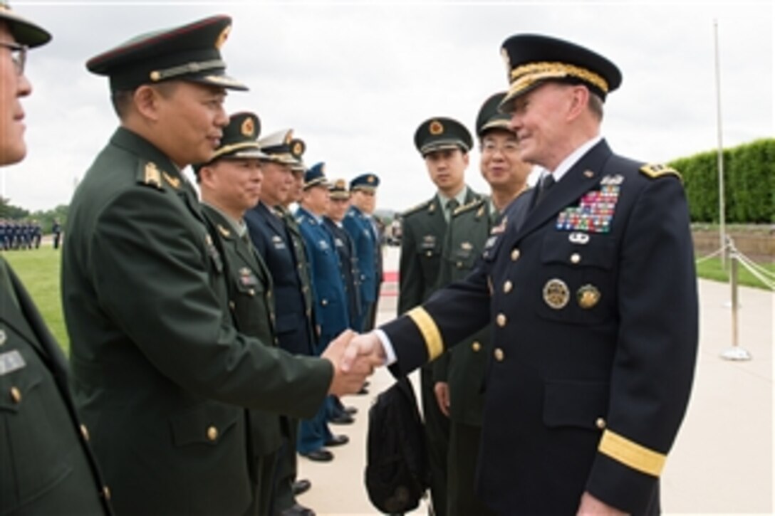 U.S. Army Gen. Martin E. Dempsey, chairman of the Joint Chiefs of Staff, shakes hands with a Chinese officer during a full-honor welcome ceremony for Chinese Army Gen. Fang Fenghui, chief of the general staff, at the Pentagon, May 15, 2014. It was the first full-honor ceremony Dempsey has hosted since 2012.