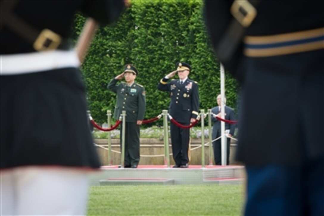 U.S. Army Gen. Martin E. Dempsey, right, chairman of the Joint Chiefs of Staff, and Chinese Army Gen. Fang Fenghui, chief of the general staff, salute during a full-honor arrival ceremony at the Pentagon, May 15, 2014. This is the first full-honor ceremony Dempsey has hosted since 2012.