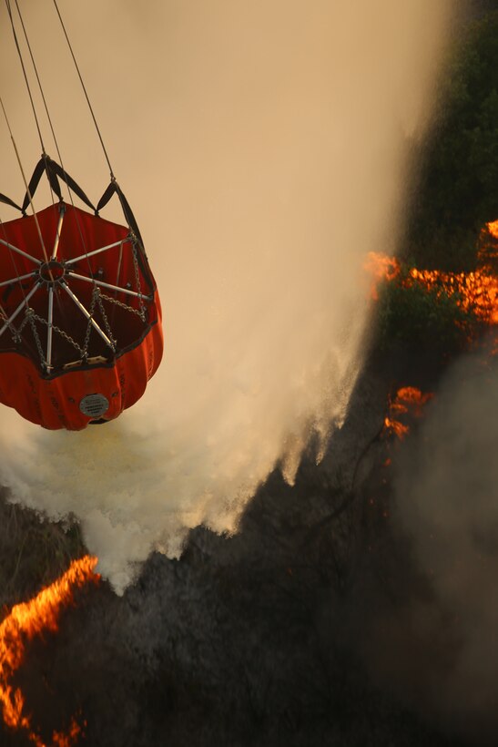 U.S. Marines with Marine Medium Helicopter Squadron (HMM) 364, 3rd Marine Aircraft Wing from Marine Corps Air Station Camp Pendleton, assist California Department of Forestry and Fire Protection and local firefighting agencies containing the Fires in Camp Pendleton, Calif. May 16, 2014. (U.S. Marine Corps photograph by GySgt. Donald Bohanner/Released)