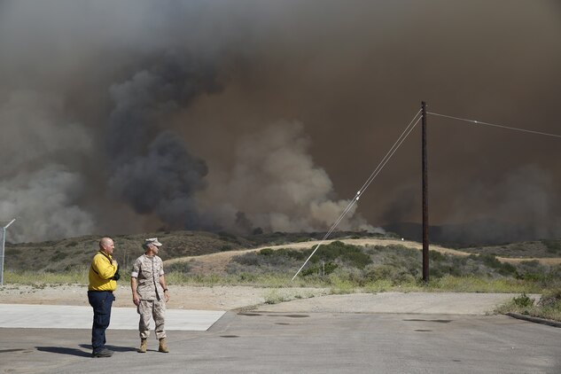 Brig. Gen. John W. Bullard surveys the fire in the Las Pulgas Area. The Las Pulgas fire started at 3:15 p.m. Thursday and effected Camp las Pulgas, Camp Margarita, Camp Las Flores, the 32 Area, the 22 Area and the 23 Area. Camp Las Pulgas was evacuated to the School of Infantry parade deck, Camp Las Flores, Camp Margarita and the 32 Area were evacuated to the I MEF parade deck in Camp Del Mar. The 22 and 23 Areas were ordered to shelter in place. Bullard is the commanding general of Marine Corps Installations West and Marine Corps Base Camp Pendleton. 