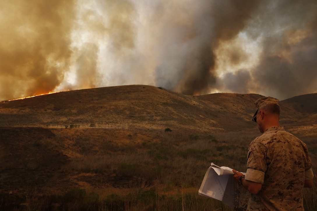 Brig. Gen. John W. Bullard surveys the fire in the Las Pulgas Area. The Las Pulgas fire started at 3:15 p.m. Thursday and effected Camp las Pulgas, Camp Margarita, Camp Las Flores, the 32 Area, the 22 Area and the 23 Area. Camp Las Pulgas was evacuated to the School of Infantry parade deck, Camp Las Flores, Camp Margarita and the 32 Area were evacuated to the I MEF parade deck in Camp Del Mar. The 22 and 23 Areas were ordered to shelter in place. Bullard is the commanding general of Marine Corps Installations West and Marine Corps Base Camp Pendleton. 