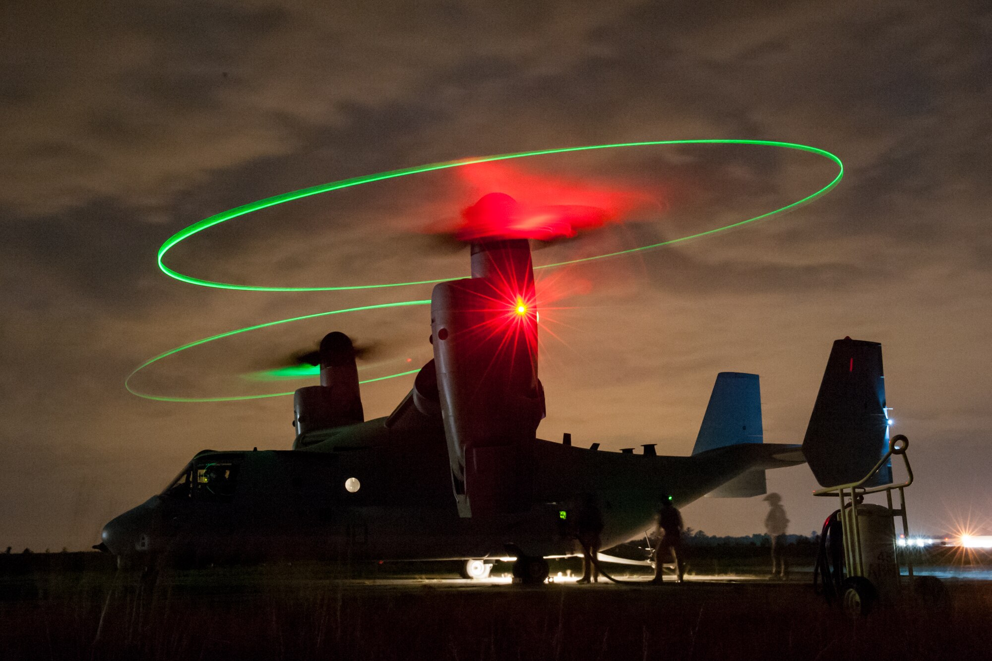 U.S. Marines assigned to the 273rd Marine Wing Support Squadron, Air Operations Company, from Marine Corps Air Station Beaufort, S.C., execute fueling an MV-22 Osprey at a forward air refueling point at McEntire Joint National Guard Base, S.C. on May 14, 2014. The Marines conduct joint operations alongside elements of the South Carolina Air and Army National Guard, these exercises are crucial to the ongoing success of operational readiness and deployments around the world.  (U.S. Air National Guard photo by Tech Sgt. Jorge Intriago/Released)