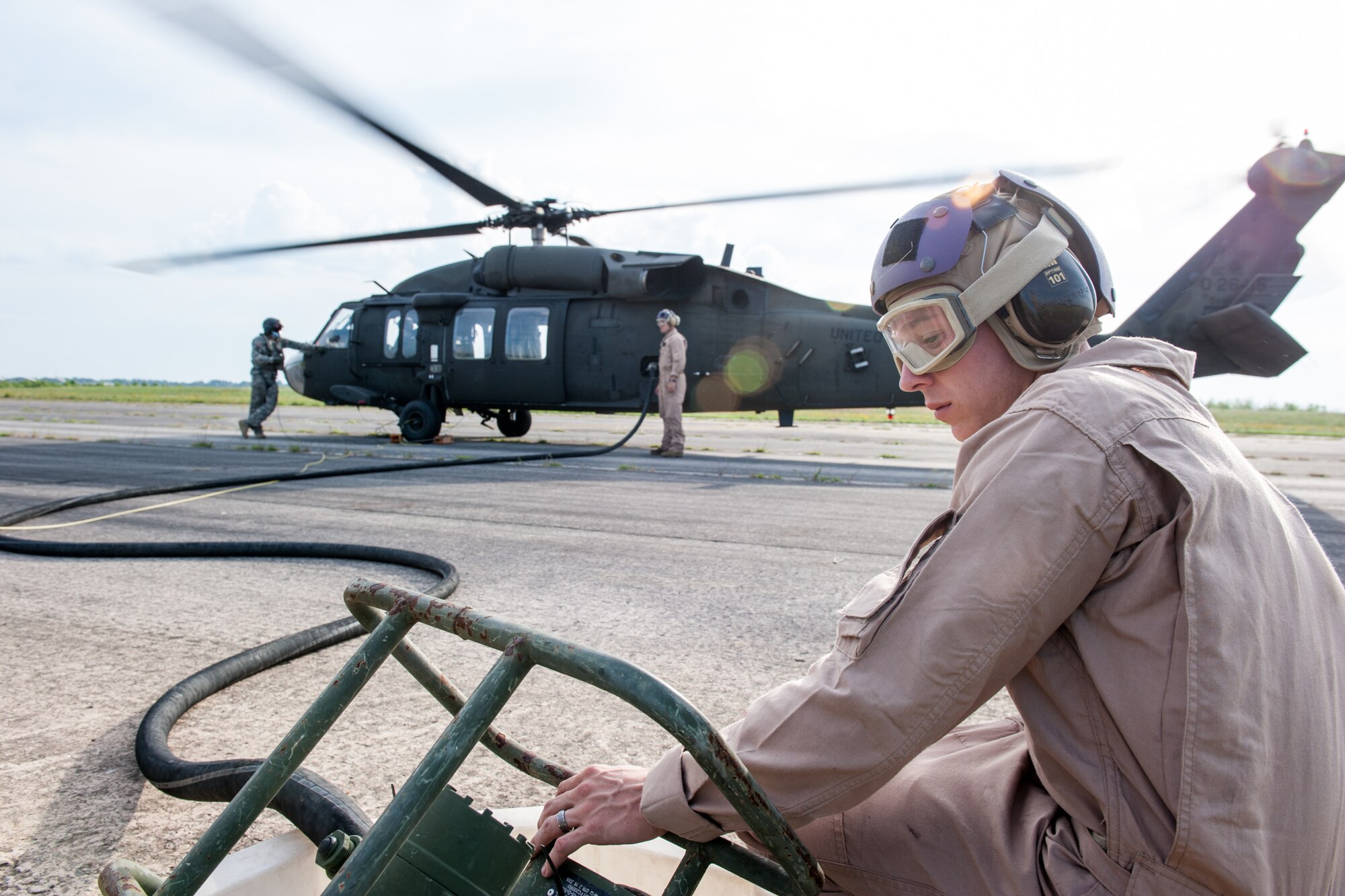 U.S. Marine Cpl. Michael T. Ransom, assigned to the 273rd Marine Wing Support Squadron, Air Operations Company, monitors the amount of fuel transferred to the UH-60 Blackhawk during forward air refueling point operations at McEntire Joint National Guard Base, S.C. on May 14, 2014. Elements of the South Carolina Air and Army National Guard and the U.S. Marines conduct joint operations which are crucial to the ongoing success of operational readiness and deployments around the world.  (U.S. Air National Guard photo by Tech Sgt. Jorge Intriago/Released)