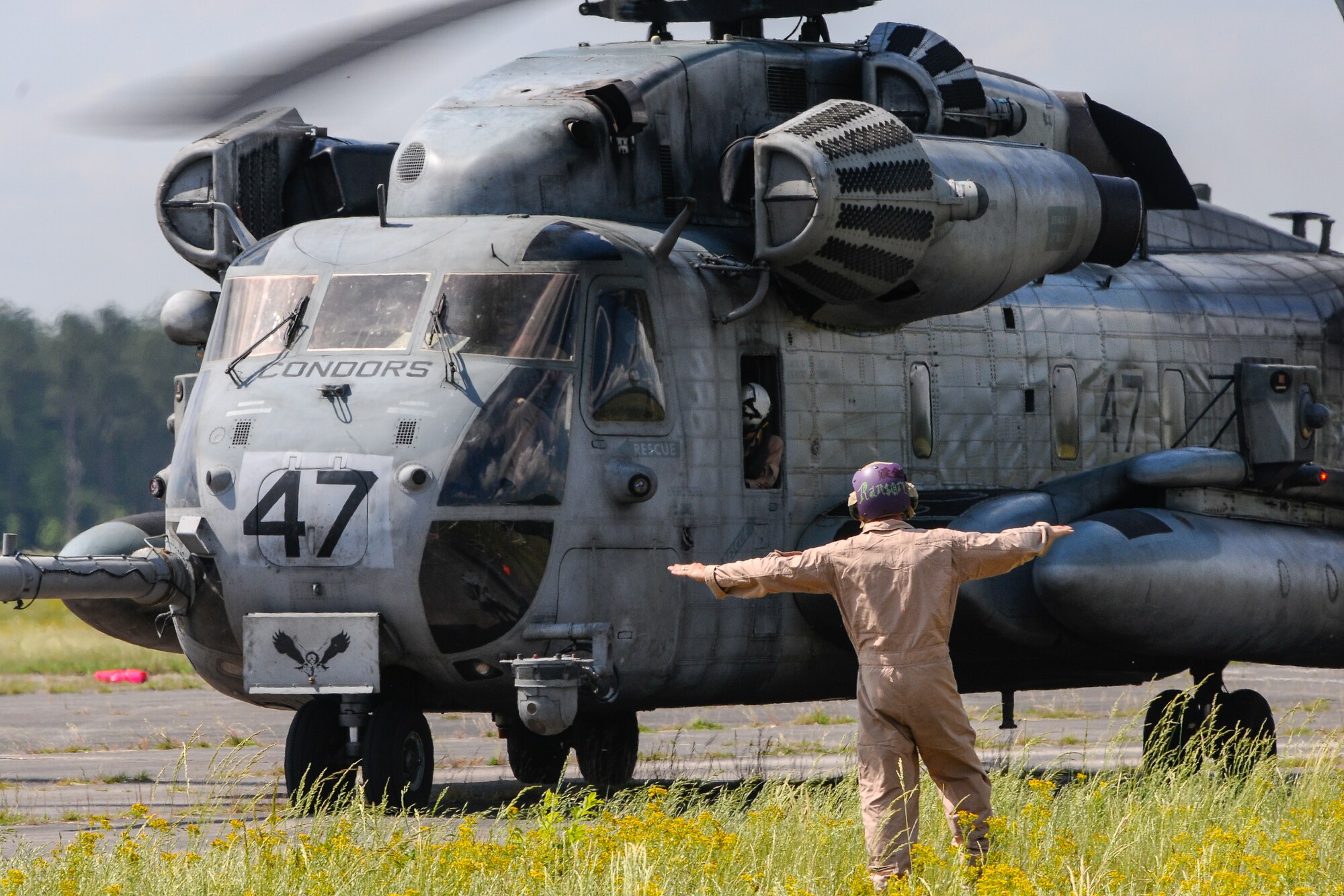 A U.S. Marine assigned to the 273rd Marine Wing Support Squadron, Air Operations Company, marshals a CH-53 Sea Stallion during forward air refueling point operations at McEntire Joint National Guard Base, S.C. on May 14, 2014. Elements of the South Carolina Air and Army National Guard and the U.S. Marines conduct joint operations which are crucial to the ongoing success of operational readiness and deployments around the world.  (U.S. Air National Guard photo by Tech Sgt. Jorge Intriago/Released)