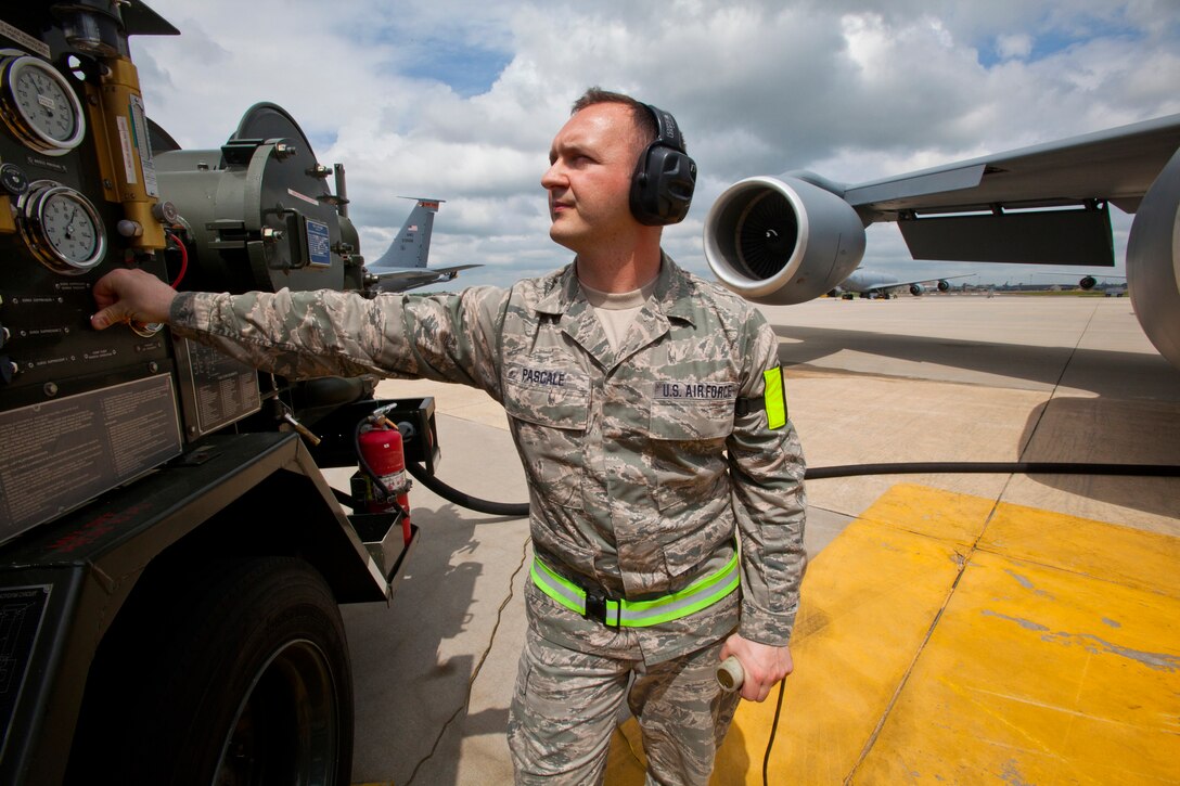 Senior Airman Victor T. Pascale, a fuels journeyman with the Petroleum, Oils and Lubricants shop, 108th Wing Logistics Readiness Squadron, monitors pressure gauges while refueling a KC-135R Stratotanker with the R-12 hydrant-servicing vehicle at Joint Base McGuire-Dix-Lakehurst, N.J., May 15, 2014. (U.S. Air National Guard photo by Master Sgt. Mark C. Olsen/Released)