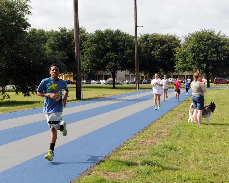 Barksdale children run on the Senior Airman Bryan R. Bell Fitness Center track during a two-mile Kids Run on Barksdale Air Force Base, La., May 17, 2014. More than 100 Team Barksdale members participated in the Kids Run. (U.S. Air Force photo/Senior Airman Benjamin Gonsier)