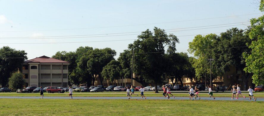 Barksdale children run on the Senior Airman Bryan R. Bell Fitness Center track during a one-mile Kids Run on Barksdale Air Force Base, La., May 17, 2014. More than 100 Team Barksdale members participated in the Kids Run. (U.S. Air Force photo/Senior Airman Benjamin Gonsier)