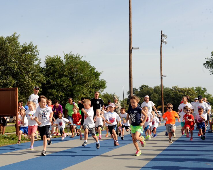Barksdale children take off during the half-mile Kids Run on Barksdale Air Force Base, La., May 17, 2014. The Kids Run featured three different runs, a half-mile run for 5 and 6 year olds, a one-mile run for 7 and 8 year olds and a two-mile run for 9 to 13 year olds. (U.S. Air Force photo/Senior Airman Benjamin Gonsier)
