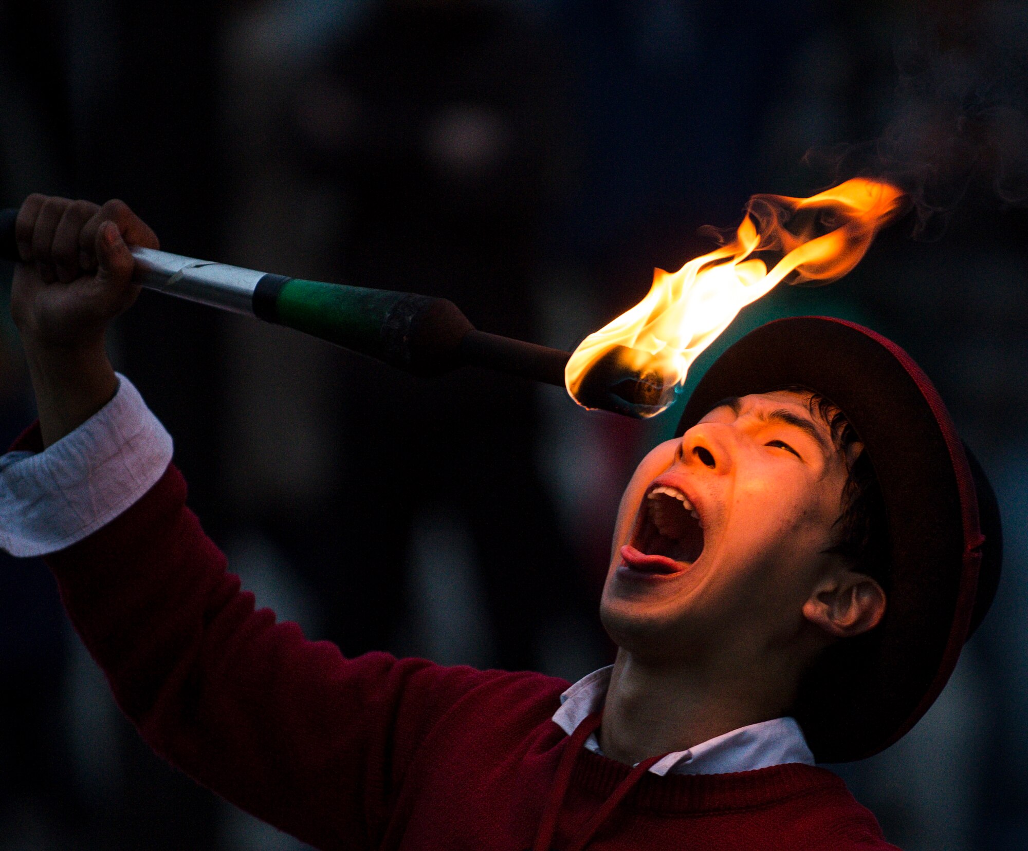 A street entertainer prepares to digest fire in Yeouido Park April 12, 2014, in Seoul, Republic of Korea. The performance included several juggling routines with knives and fire. (U.S. Air Force photo by Staff Sgt. Jake Barreiro)