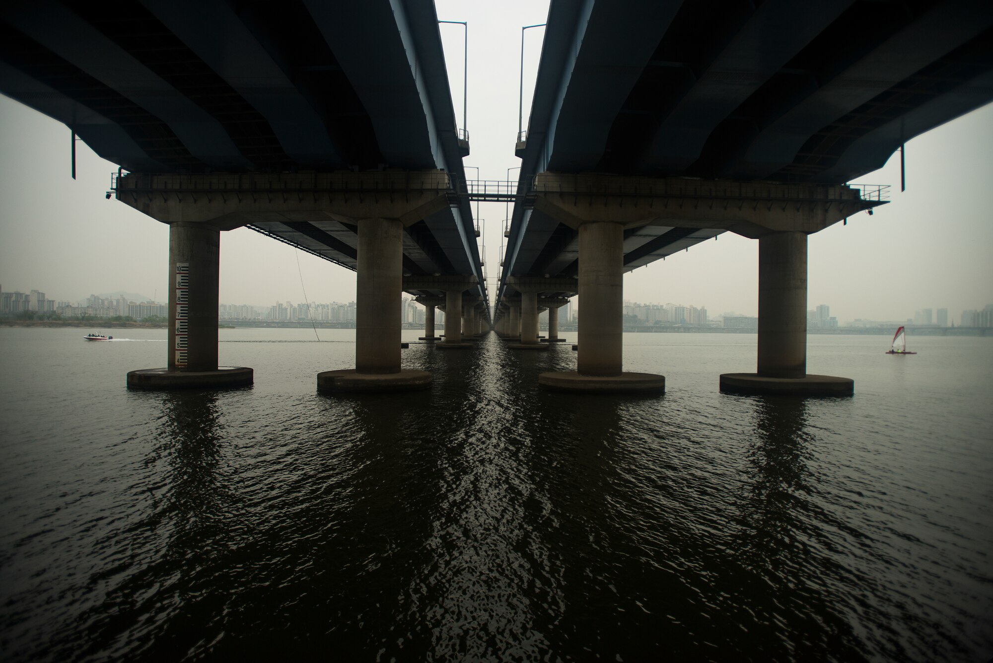 A speed and sail boat go opposite directions underneath a bridge in Yeouido Park April 12, 2014, in Seoul, Republic of Korea. Sailing in the Han River is a common spring and summertime activity in the South Korean capital. (U.S. Air Force photo by Staff Sgt. Jake Barreiro)