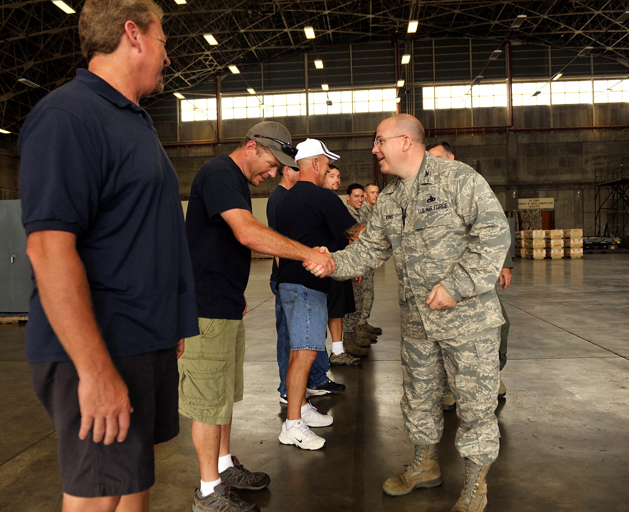 U.S. Air Force Col. Jeffrey King, 18th Maintenance Group commander, shakes hands with members of the 18th MXG and members of Boeing after their two-year F-15 Eagle modification program on Kadena Air Base, Japan, May 15, 2014. The radar upgrade program replaced the mechanically-scanned antenna on F-15 aircraft with an active electronically-scanned array antenna that provides improved reliability and performance for pilots. (U.S. Air Force photo by Naoto Anazawa)