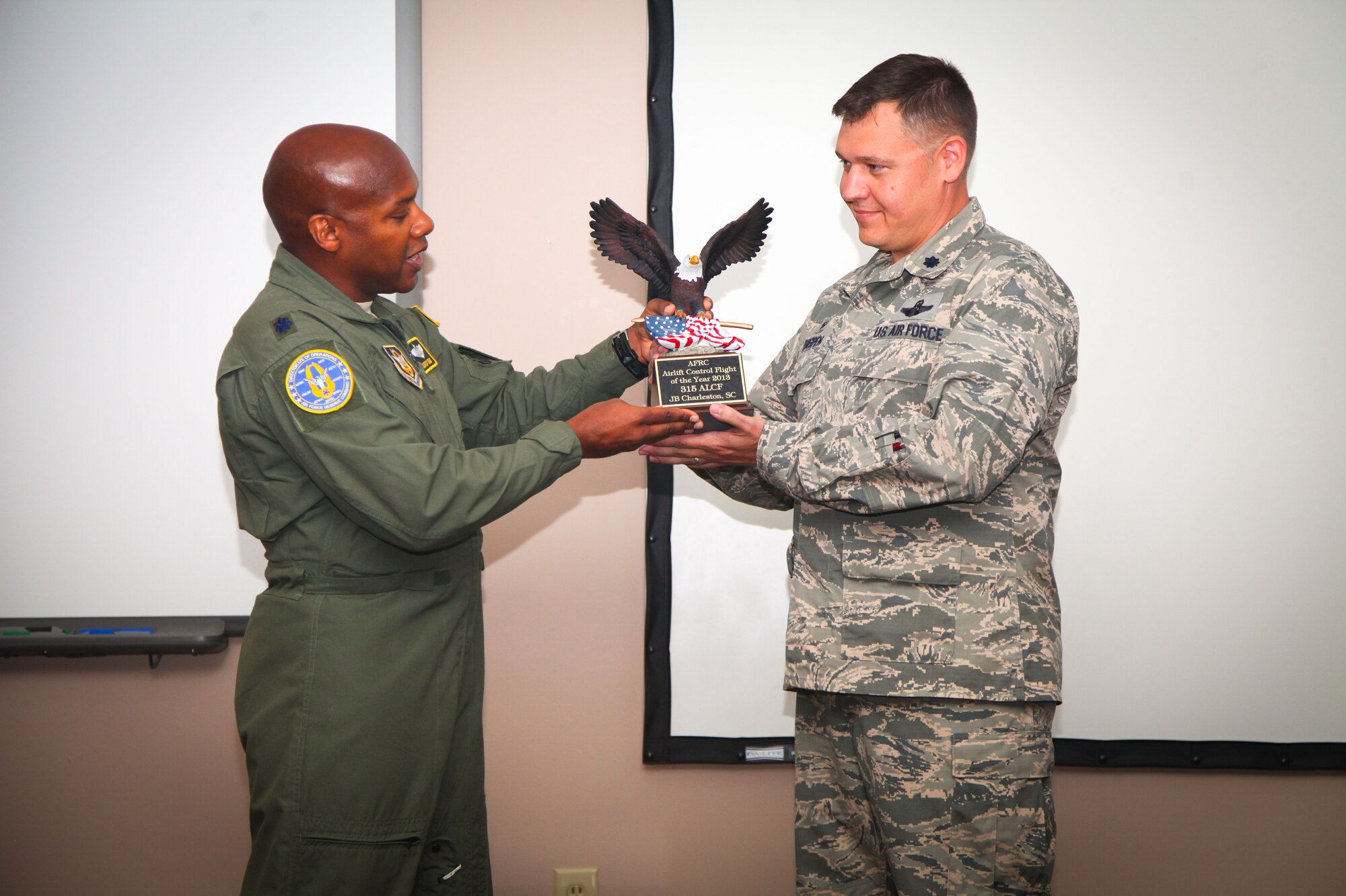 Lt. Col. Gordy Griggs (left) presents the Air Force Reserve Command Airlift Control Flight of the Year award to 315th ALCF commander Lt. Col. Lamar Thigpen today in a ceremony in the Yonkie Auditorium here at Joint Base Charleston, S.C. The ALCF received the award for top performance among ALCF's in 2013. (Photos by Staff Sgt. Rashard Coaxum/released)