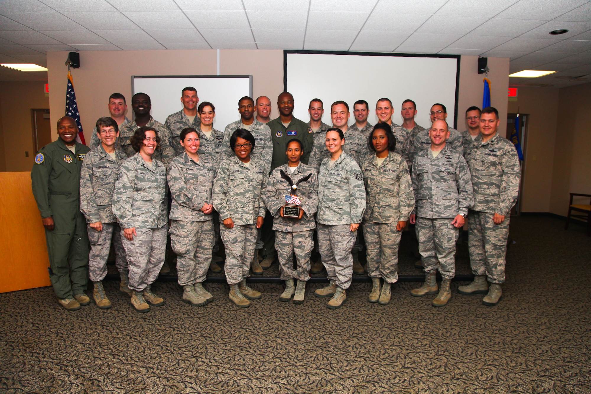 Members of the 315th Airlift Wing Control Flight, from here at Joint Base Charleston, pose together for a photo after receiving the Air Force Reserve Command's ALCF of the Year award today, in the Yonkie Auditorium here. The ALCF received the award for top performance among ALCF's in 2013. (Photos by Staff Sgt. Rashard Coaxum/released)