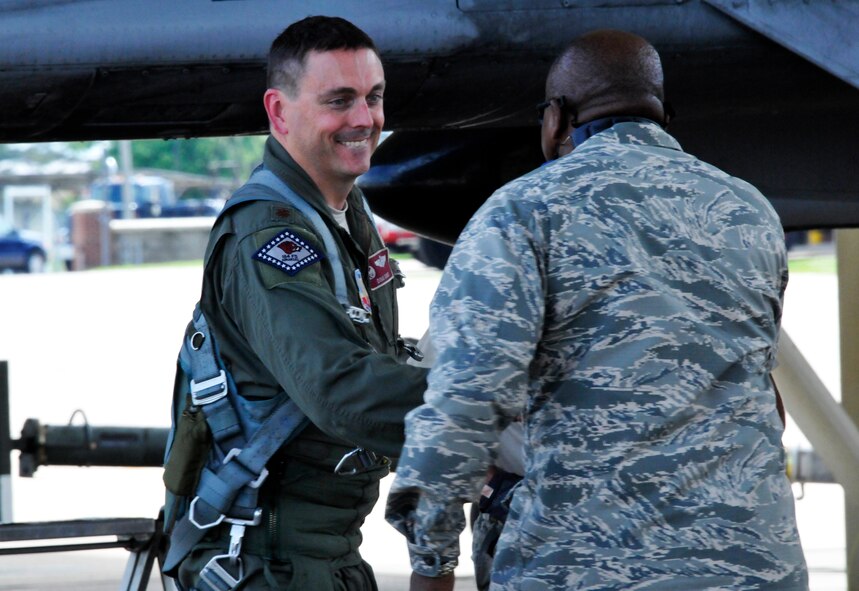 Maj. Doug Davis, 188th Detachment 1 commander, left, shakes hands with Lt. Col. Anderson Neal, 188th Maintenance Group commander, following a historic flight. Davis and Lt. Col. Marty Dahlem, 188th Operations Support Squadron commander, performed the188th's  final A-10C Thunderbolt II “Warthog” training mission May 16 at Ebbing Air National Guard Base, Fort Smith, Arkansas. (U.S. Air National Guard photo by Tech Sgt. Josh Lewis/released)