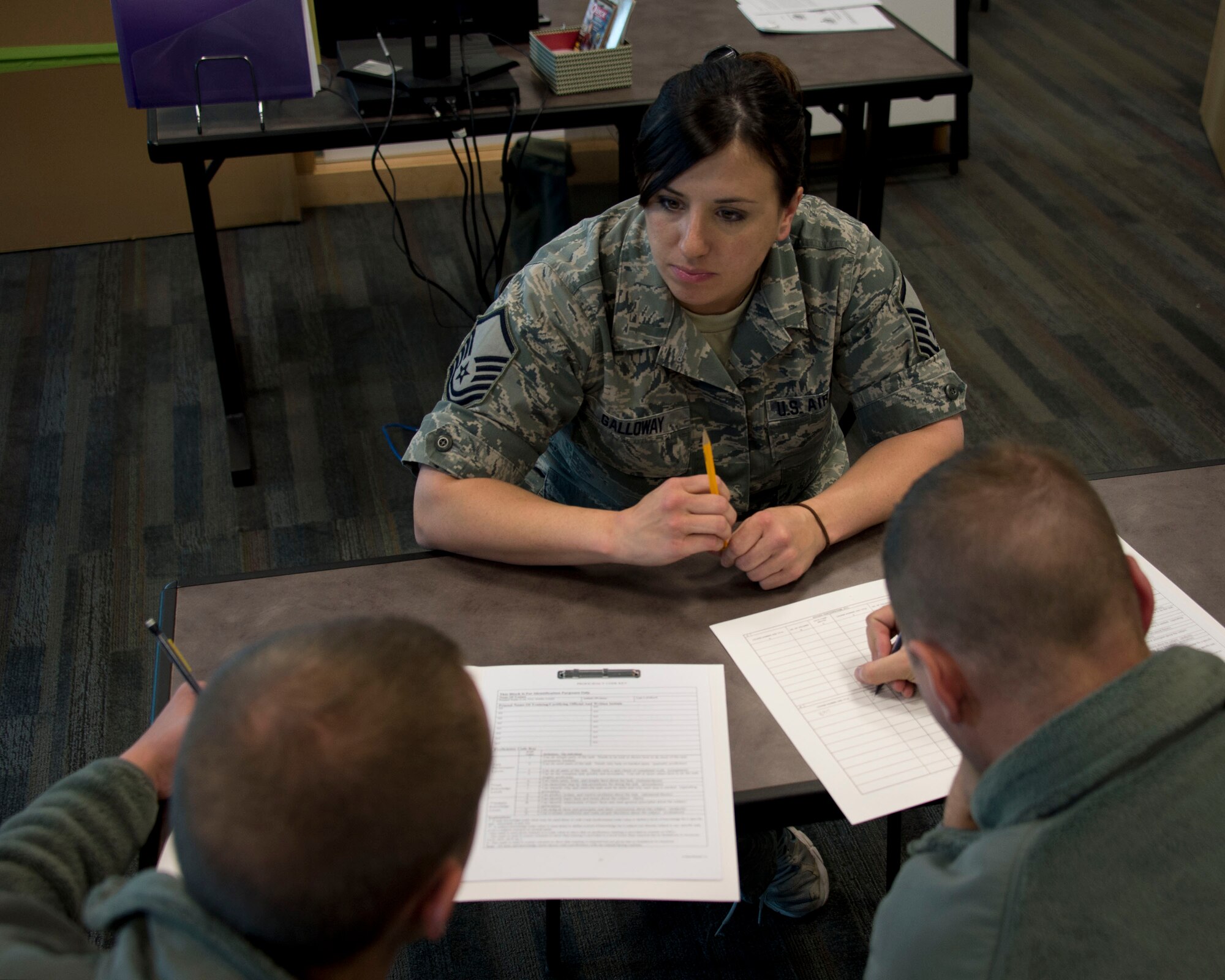 Master Sgt. Crystal Galloway, center, goes over Individual Training Records with Airman 1st Class Peter Robey and Airman 1st Class John Schonebaum in St. Paul, Minn., May 6, 2014. Galloway is the Unit Training Manager and is responsible for keeping track of the training records for the 133rd Maintenance Group.
(U.S. Air National Guard photo by Tech. Sgt. Amy M. Lovgren/Released)
