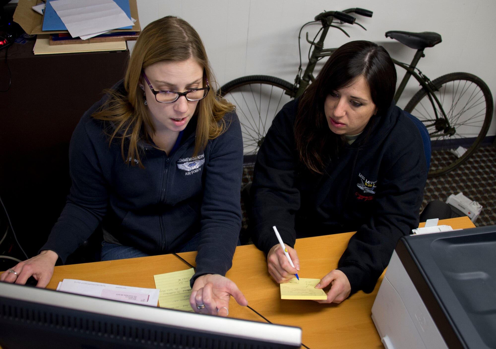 Amy Lauria, right, and Master Sgt. Crystal Galloway review Facebook posting in South St. Paul, Minnesota, Apr. 2, 2014. Galloway has been volunteering at the Commemorative Air Force Minnesota Wing for the last couple of years by helping them with social media postings and the organization and promotion of events.
 (U.S. Air National Guard photo by Tech. Sgt. Amy M. Lovgren/Released)
