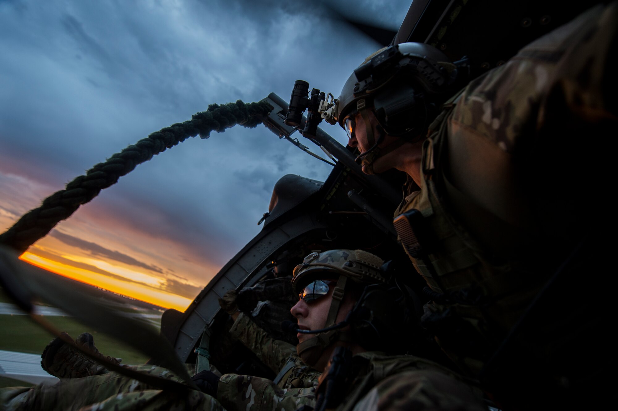 Soldiers with the 20th Special Forces Group observe the scenery before fast-roping from a UH-60 Black Hawk helicopter during Emerald Warrior 14 in Gulfport, Miss., April 30, 2014. Emerald Warrior is a U.S. Special Operations Command-sponsored two-week joint/combined tactical exercise designed to provide realistic military training in an urban setting. (U.S. Air Force photo/Senior Airman Jodi Martinez)