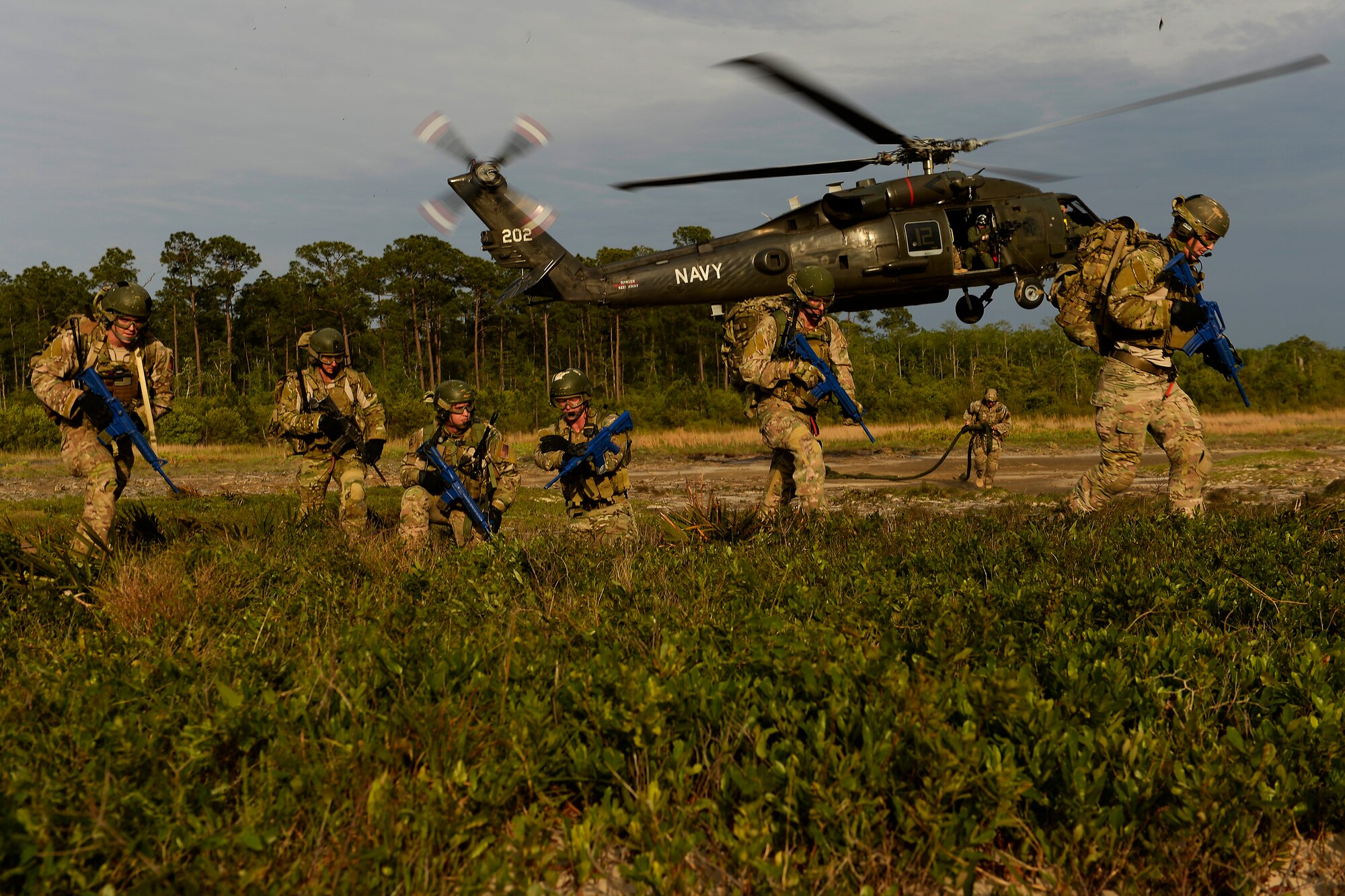 Combat controllers conduct fast-rope insertion training using a U.S. Navy HH-60H Seahawk helicopter assigned to Helicopter Sea Combat Squadron 84 at Hurlburt Field, Fla., May 2, 2014, during Emerald Warrior 2014. Emerald Warrior is a U.S. Special Operations Command-sponsored two-week joint/combined tactical exercise designed to provide realistic military training in an urban setting. (U.S. Air Force photo/Staff Sgt. Tim Chacon)