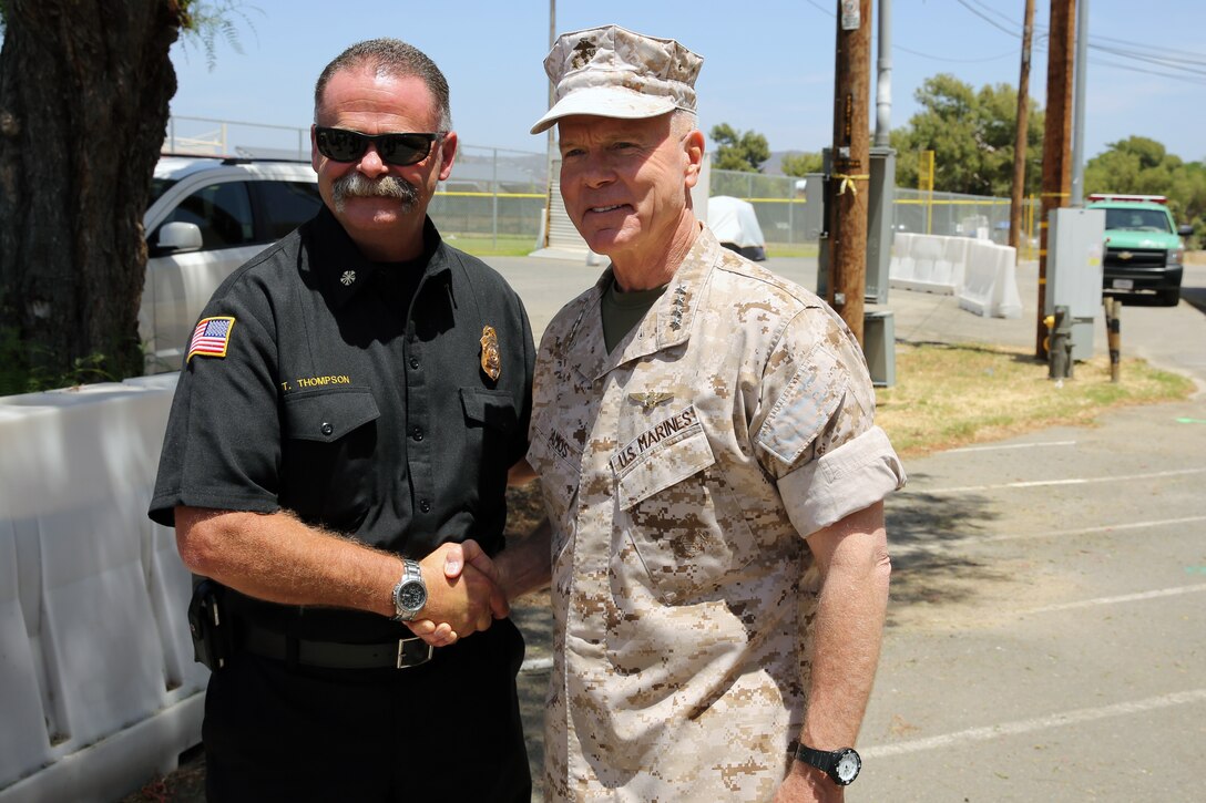The 35th Commandant of the Marine Corps General James F. Amos, the 17th Sergeant Major of the Marine Corps, Sgt. Maj. Micheal P. Barrett visit Marine Corps Base Camp Pendleton to speak with the local, state and federal firefighting departments who participated in firefighting efforts during the Basilone Complex Fire. Camp Pendleton Fire Department, CAL FIRE, the U.S. Forest Service, and many more local fire departments combined their efforts with military assets to combat the blazes across the base.