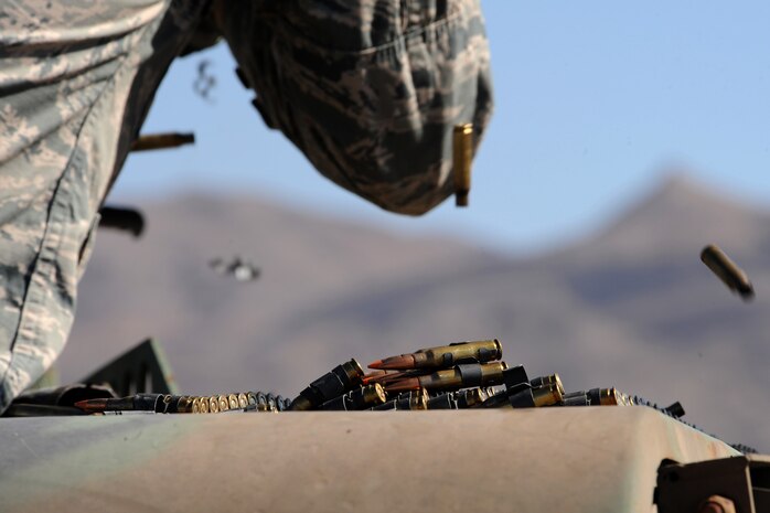 Belts of 7.62 mm ammunition lay on top of a Humvee during a weapons familiarization event for base leadership in honor of National Police Week May 15, 2014, at Nellis Air Force Base, Nev.  National Police Week is held the calendar week in which May 15 falls and honors all police forces. (U.S. Air Force photo by Tech. Sgt. Taylor Worley)