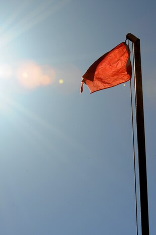 The range flag flies above the Nellis Small Arms Range May 15 at Nellis Air Force Base, Nev. The range flag signals to all the range is in use and live fire is taking place.  (U.S. Air Force photo by Tech. Sgt. Taylor Worley)