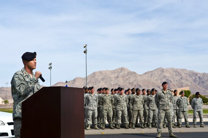 U.S. Air Force Maj. Richard Martin, 99th Security Forces Squadron commander, speaks to military members and civilians at Freedom Park during a final guard mount and formal retreat ceremony as part of National Police Week May 16, 2014, at Nellis Air Force Base, Nev. The final guard mount and retreat ceremony was held in honor of security forces Airmen and civilian policemen killed in the line of duty. (U.S. Air Force photo by Senior Airman Christopher Tam)