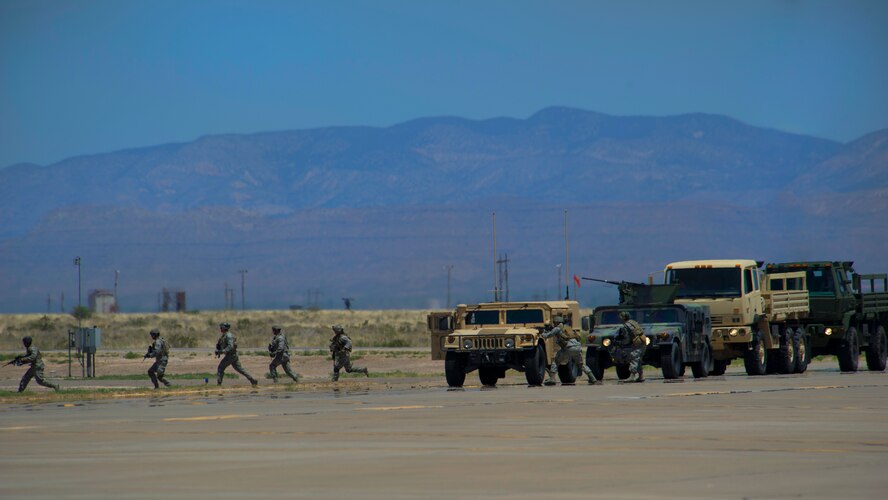 The 49th Security Forces Squadron respond to a simulated confrontation demonstrating close air support capabilities of the F-16 Fighting Falcon during the Open House event at Holloman Air Force Base, N.M., May 10. Team Holloman hosted an Open House showcasing over 50 aircraft and the day-to-day duties of Holloman Airmen. With live flying demonstrations and static displays, thousands of guests attended the event to get a close-up look at the base’s assets and capabilities. Guests were able to view various aircraft, visit numerous vendors, and witness ground demonstrations from squadrons around the base. (U.S. Air Force photo by Airman 1st Class Aaron Montoya / Released)