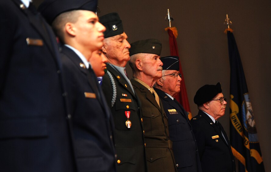 Current and former military members stand in formation during a retreat ceremony at the base auditorium May 16. The retreat ceremony was part of Retiree Appreciation Weekend. (U.S. Air Force photo/Airman 1st Class Joshua Smoot))