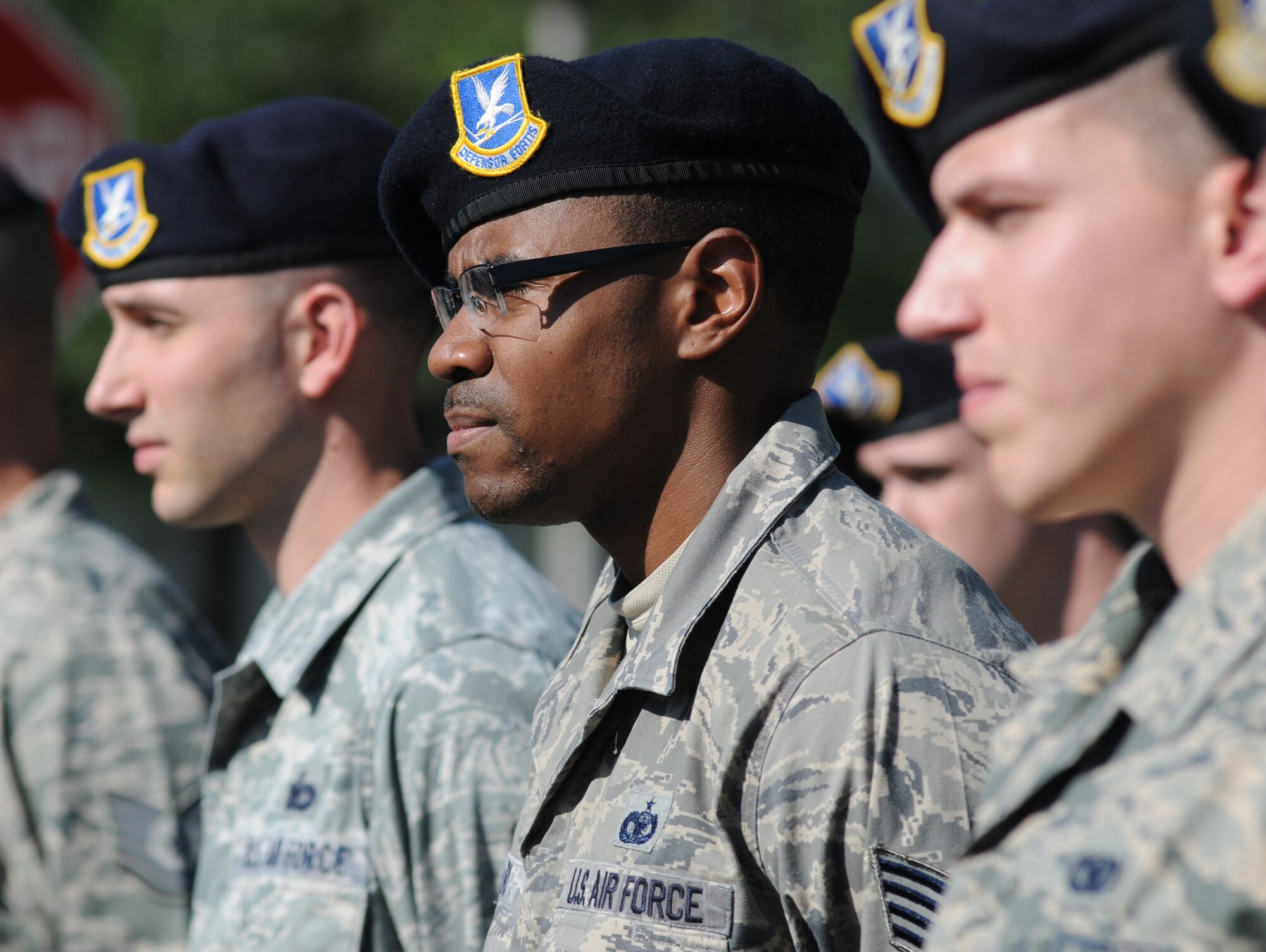 Staff Sgt. George Clark , 81st Security Forces Squadron, (center), stands among fellow members of the 81st SFS during a retreat ceremony hosted by the 81st SFS May 15, 2014, at Keesler Air Force Base, Miss.  The retreat ceremony was held in memory of all law enforcement officers in the State of Mississippi, Air Force Officers of Special Investigations and 81st SFS members who have lost their lives in the line of duty over the past year.  (U.S. Air Force photo by Kemberly Groue)