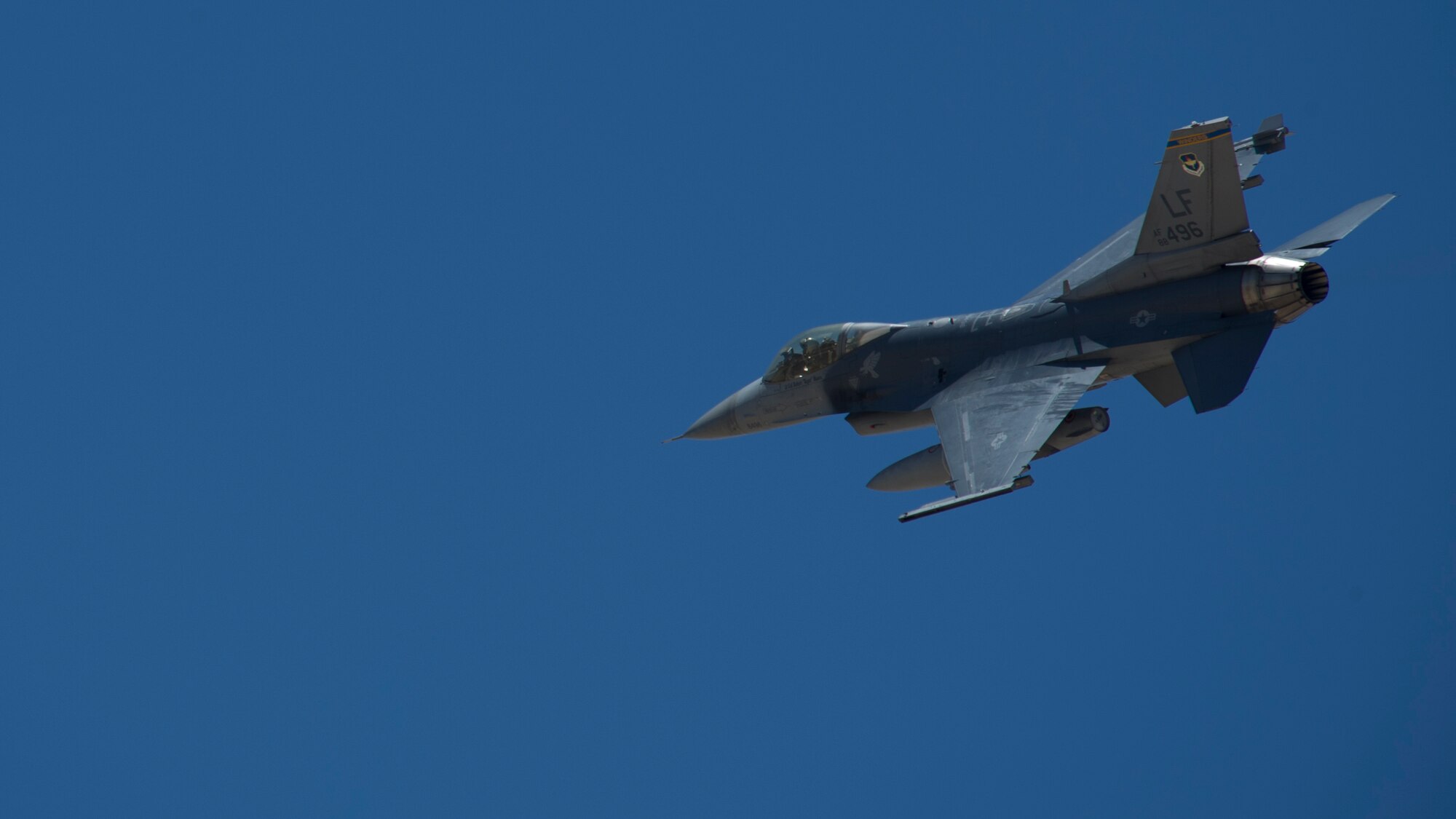An F-16 Fighting Falcon soars through the skies of the Tularosa Basin during the Open House event at Holloman Air Force Base, N.M., May 10. Team Holloman hosted an Open House showcasing over 50 aircraft and the day-to-day duties of Holloman Airmen. With live flying demonstrations and static displays, thousands of guests attended the event to get a close-up look at the base’s assets and capabilities. Guests were able to view various aircraft, visit numerous vendors, and witness ground demonstrations from squadrons around the base. (U.S. Air Force photo by Airman 1st Class Aaron Montoya / Released)