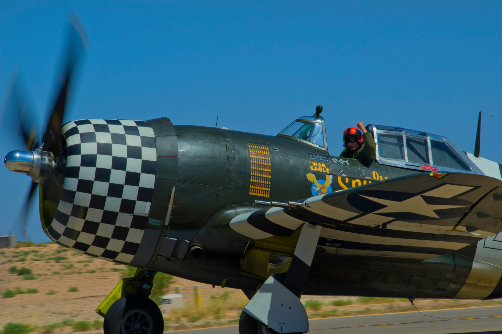 The P-47 Thunderbolt takes off for the heritage flight with the F-22 Raptor during the Open House event at Holloman Air Force Base, N.M., May 10. Team Holloman hosted an Open House showcasing over 50 aircraft and the day-to-day duties of Holloman Airmen. With live flying demonstrations and static displays, thousands of guests attended the event to get a close-up look at the base’s assets and capabilities. Guests were able to view various aircraft, visit numerous vendors, and witness ground demonstrations from squadrons around the base. (U.S. Air Force photo by Airman 1st Class Aaron Montoya / Released)