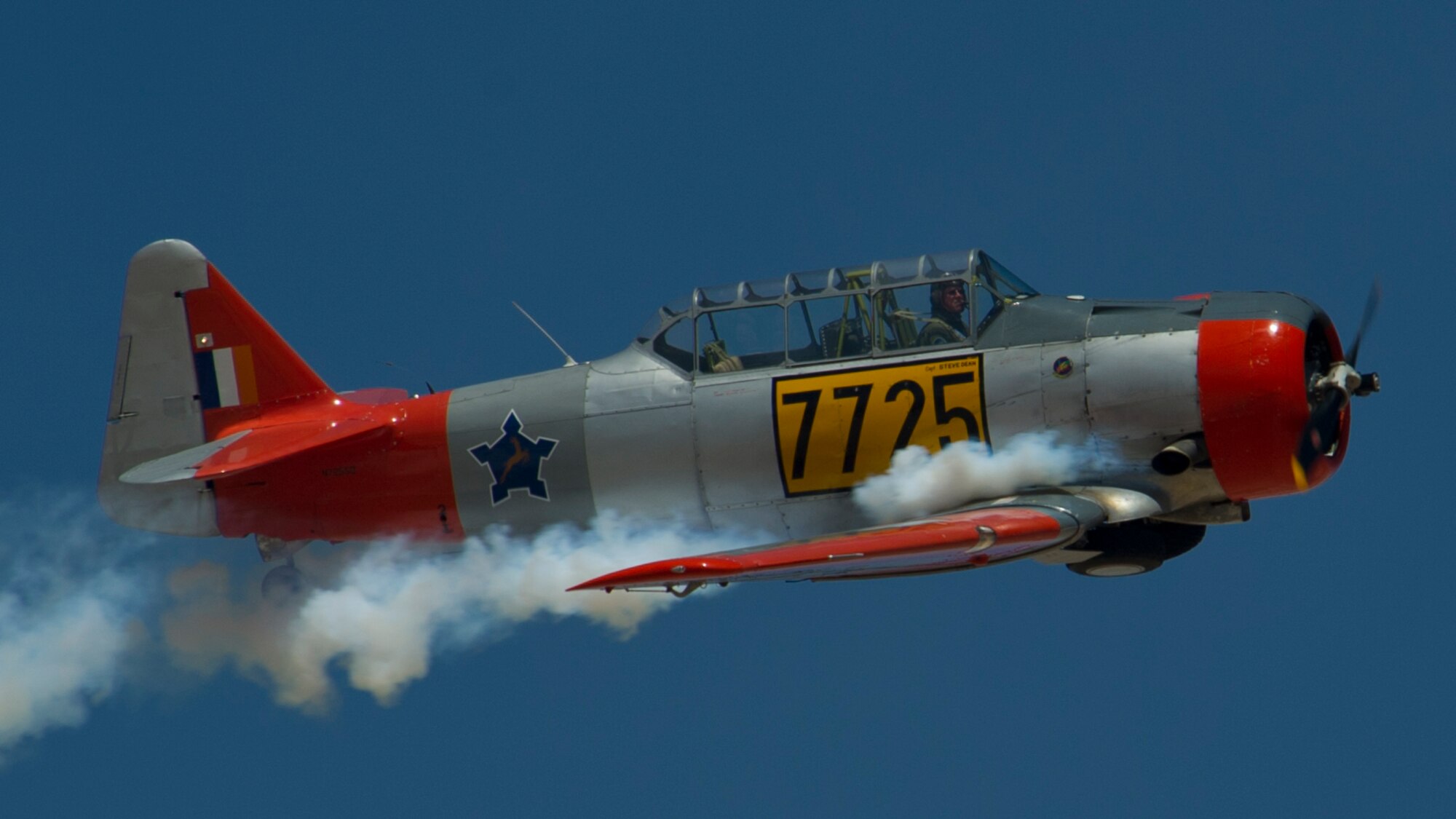 An AT-6 Texan soars through the skies of the Tularosa Basin during the Open House event at Holloman Air Force Base, N.M., May 10. Team Holloman hosted an Open House showcasing over 50 aircraft and the day-to-day duties of Holloman Airmen. With live flying demonstrations and static displays, thousands of guests attended the event to get a close-up look at the base’s assets and capabilities. Guests were able to view various aircraft, visit numerous vendors, and witness ground demonstrations from squadrons around the base. (U.S. Air Force photo by Airman 1st Class Aaron Montoya / Released)