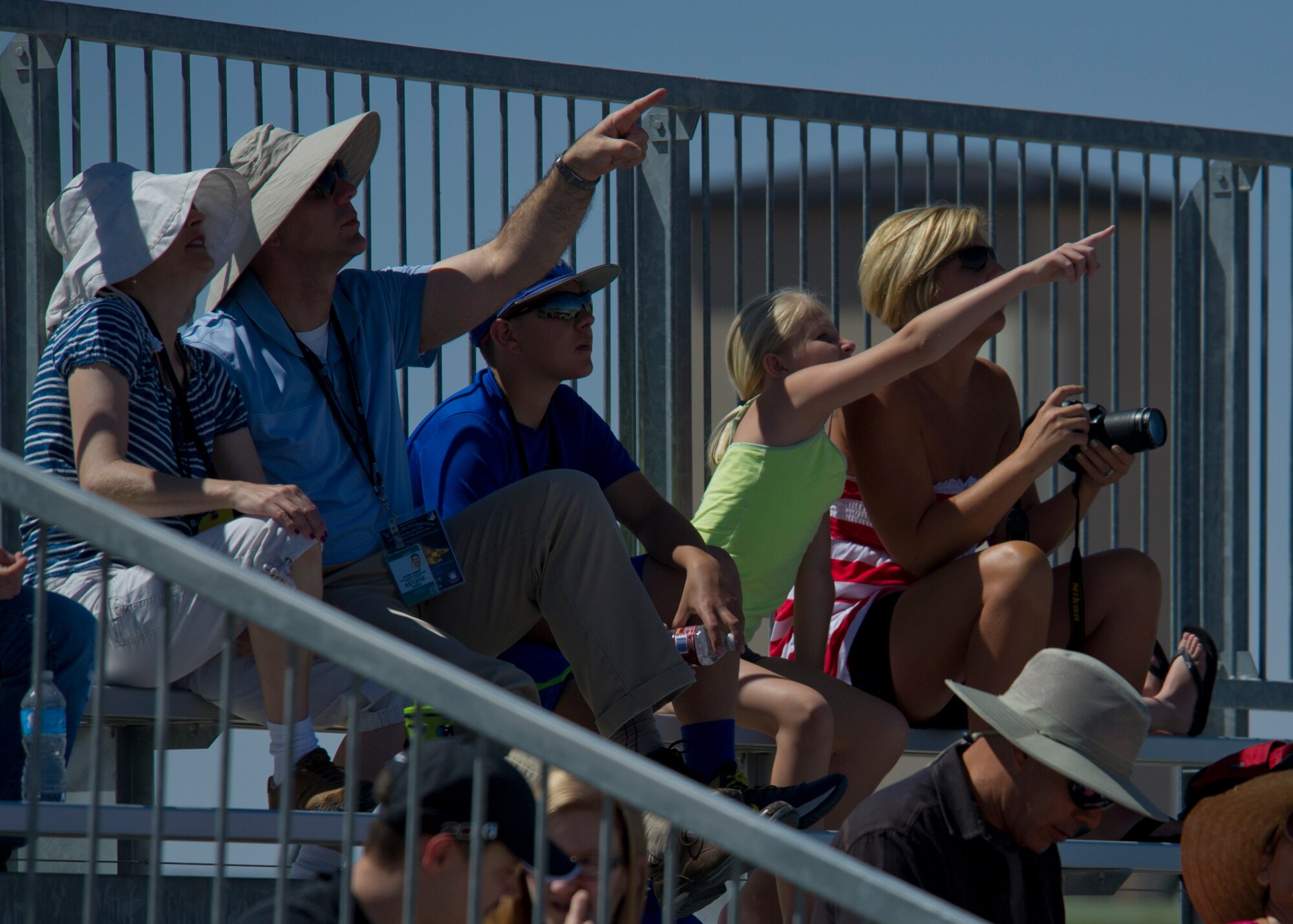 Visitors watch as aircraft fly over the Tularosa Basin during the Open House event at Holloman Air Force Base, N.M., May 10. Team Holloman hosted an Open House showcasing over 50 aircraft and the day-to-day duties of Holloman Airmen. With live flying demonstrations and static displays, thousands of guests attended the event to get a close-up look at the base’s assets and capabilities. Guests were able to view various aircraft, visit numerous vendors, and witness ground demonstrations from squadrons around the base. (U.S. Air Force photo by Airman 1st Class Aaron Montoya / Released)