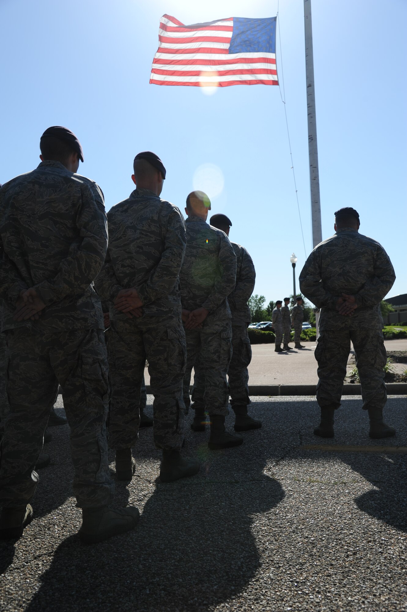 Members of the 81st Security Forces Squadron wait as the U.S. flag is prepared to be released from half-staff during a retreat ceremony hosted by the 81st SFS May 15, 2014, at Keesler Air Force Base, Miss.  The retreat ceremony was held in memory of all law enforcement officers in the State of Mississippi, Air Force Officers of Special Investigations and 81st SFS members who have lost their lives in the line of duty over the past year.  (U.S. Air Force photo by Kemberly Groue)