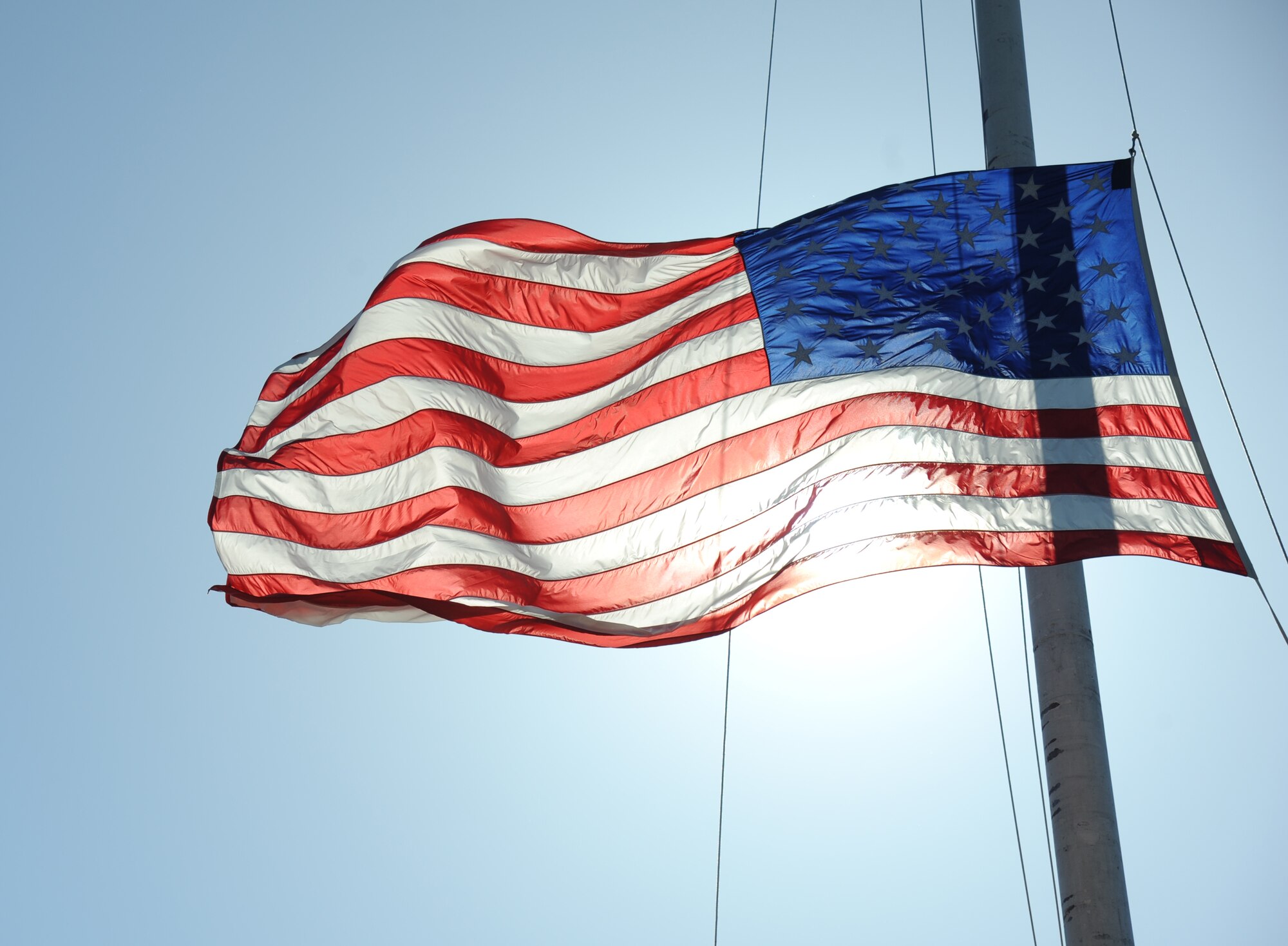 The U.S. flag is lowered during a retreat ceremony hosted by the 81st Security Forces Squadron May 15, 2014, at Keesler Air Force Base, Miss.  The retreat ceremony was held in memory of all law enforcement officers in the State of Mississippi, Air Force Officers of Special Investigations and 81st SFS members who have lost their lives in the line of duty over the past year.  (U.S. Air Force photo by Kemberly Groue)