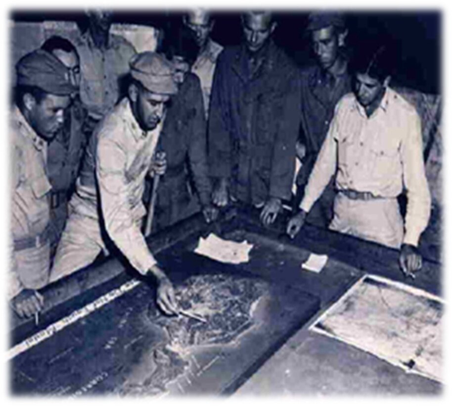 U.S. Army Col. George M. Jones, left, 503rd Regimental Combat Team commander, points out a location on a map of Corregidor Island and discusses a plan of attacked with Lt. Col. John H. Lackey Jr., far right, 317th Troop Carrier Group commander, in February 1945, at Mindoro Island, Philippines. Gen. Wainwright, along with 11,000 Filipino and American troops, surrendered Corregidor to the Japanese in April 1942, after five months of fierce fighting. The Japanese reinforced the island as a fortress protecting the entrance to Manila Bay. During four massive airdrop waves over two days, the 317 TCG’s four squadrons of C-47s airdropped more than 2,000 503rd PIR paratroopers onto Corregidor. (Courtesy photo)