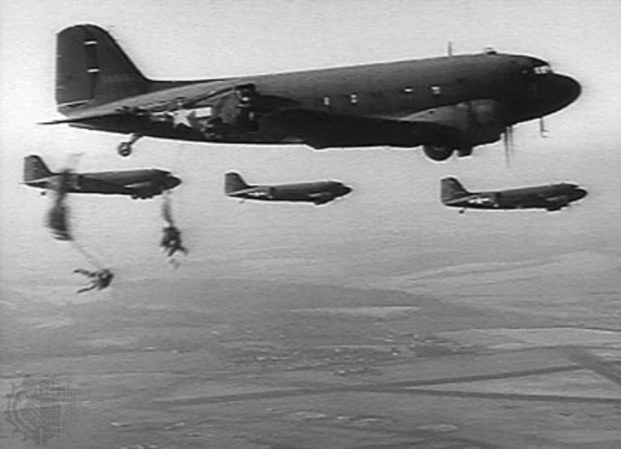 Paratroopers from the 503rd Regimental Combat Team jump from 317th Troop Carrier Group C-47s during the recapture of Corregidor Island, Philippines, in February 1945. Despite concentrated anti-aircraft and small arms fire, the 317th delivered the paratroopers over the target sustaining battle damage to more than half of its 51 aircraft. The assault on Corregidor was the most intense combat action in which the 503rd PIR engaged in during its history. During the airborne phase of the battle 12 paratroopers were killed and 267 were wounded.  Both units were awarded Presidential Unit Citations for their actions in retaking Corregidor Island. (Courtesy photo)
