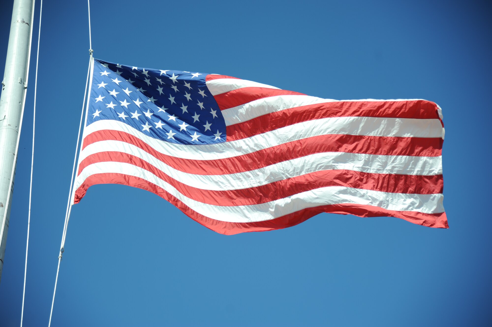 The U.S. flag is lowered during a retreat ceremony hosted by the 81st Security Forces Squadron May 15, 2014, at Keesler Air Force Base, Miss.  The retreat ceremony was held in memory of all law enforcement officers in the State of Mississippi, Air Force Officers of Special Investigations and 81st SFS members who have lost their lives in the line of duty over the past year.  (U.S. Air Force photo by Kemberly Groue)