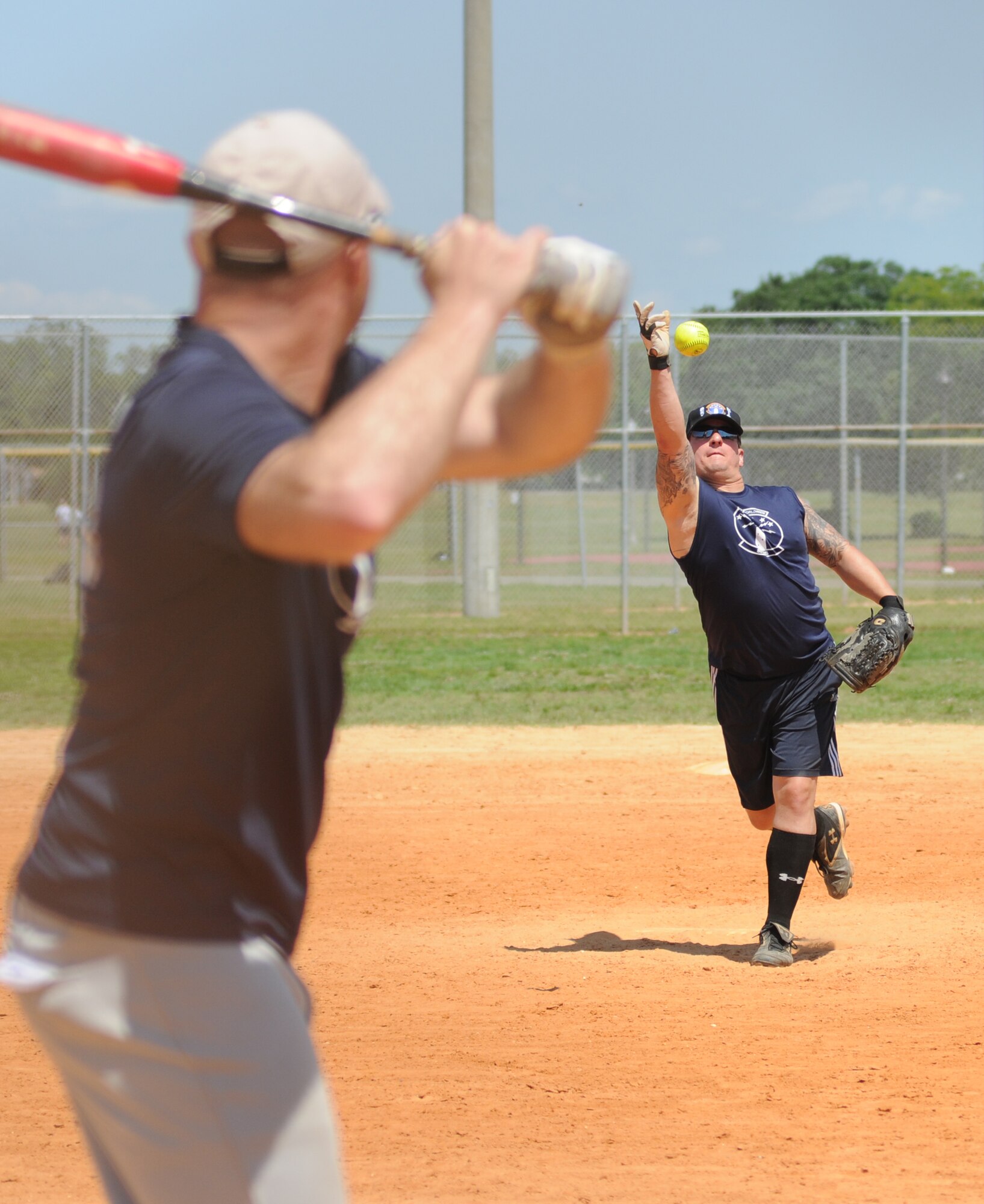 Master Sgt. Robert Hicks, 85th Engineering Installation Squadron, pitches to his team-mate, 1st Lt. Joseph Giametta, 85th EIS, during a home run derby hosted by the 81st Security Forces Squadron May 16, 2014, at Keesler Air Force Base, Miss.  The softball tournament was held in celebration of National Police Week, which recognizes the service of men and women who put their lives at risk every day. (U.S. Air Force photo by Kemberly Groue)