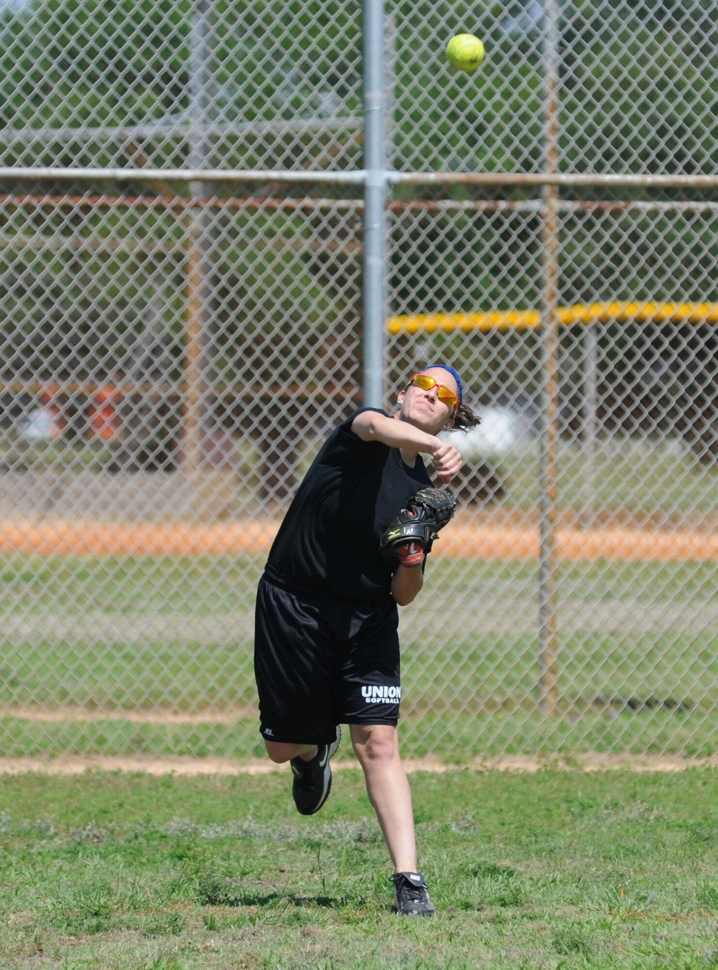 The daughter of Senior Master Sgt. Robert Degennaro, 81st Security Forces Squadron, throws the ball from left field during a softball tournament hosted by the 81st SFS May 16, 2014, at Keesler Air Force Base, Miss.  The softball tournament was held in celebration of National Police Week, which recognizes the service of men and women who put their lives at risk every day. (U.S. Air Force photo by Kemberly Groue)