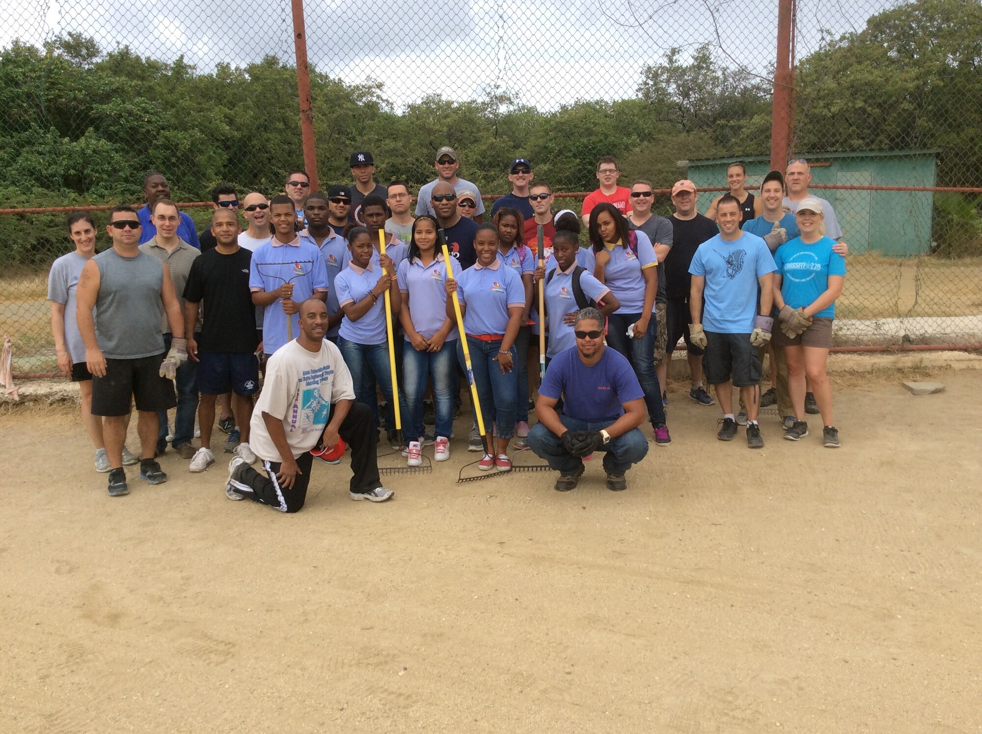 Over 50 volunteers from the U.S. Forward Operating Location cleaned the baseball field next to the Holiday Beach Hotel in Willemstad, Curacao, May 5, 2014.  US FOL volunteers, along with students from Goslinga School, spent several hours clearing debris, picking up trash, and cutting the overgrown tree branches and grass on the field.  Personnel from the US FOL often donate time and resources to various areas and programs on the island in order to express appreciation for the wonderful hospitality received from the citizens of Curacao.  The baseball field is used by Goslinga School and Saint Joseph School for recreation during school hours.  (Courtesy Photo)
