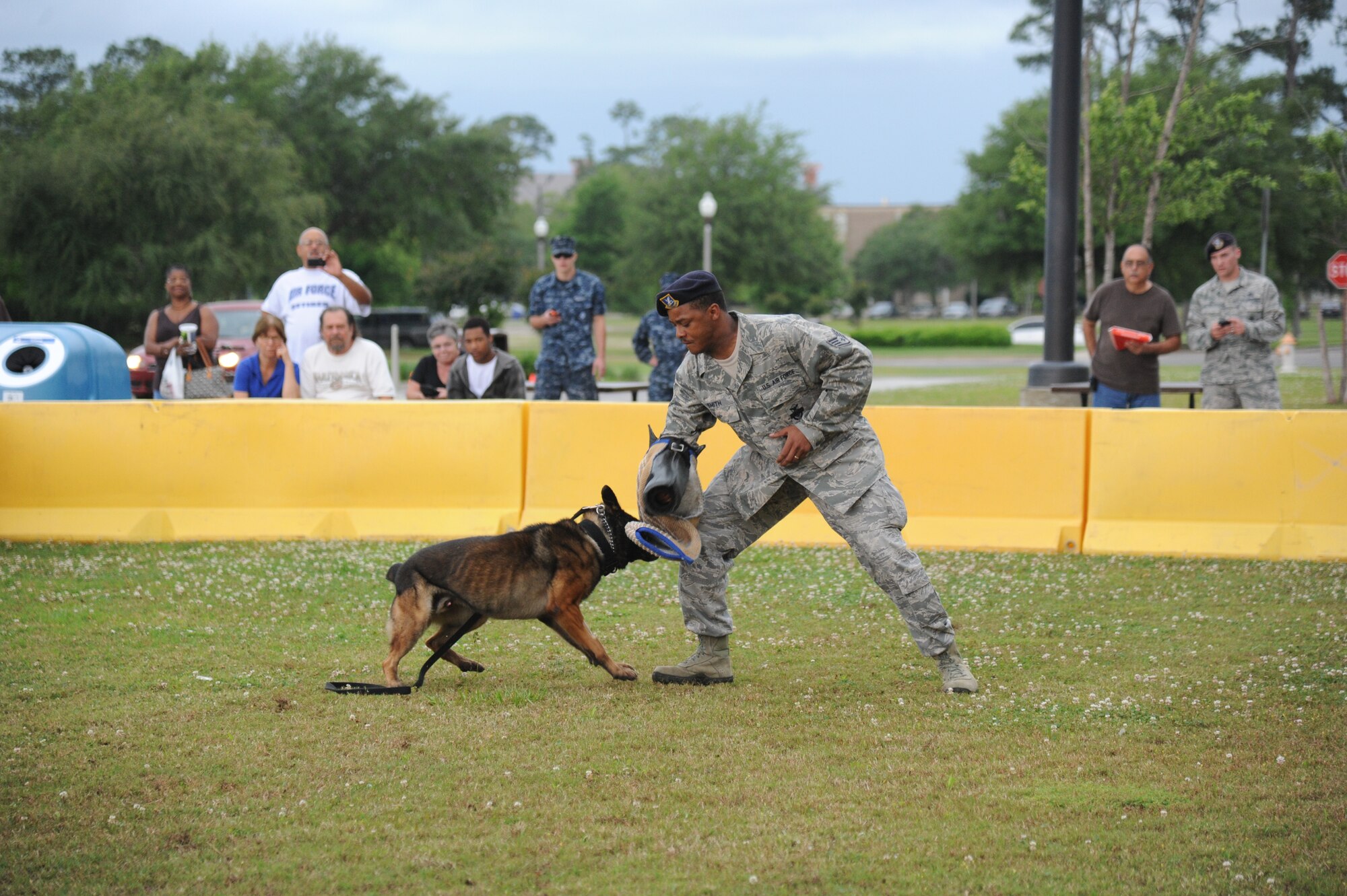 Staff Sgt. Kyle Smith, 81st Security Forces Squadron, and military working dog Toki, conduct a K9 demonstration to enhance awareness of law enforcement duties and programs May 14, 2014, in front of the base exchange, Keesler Air Force Base, Miss.  The K9 demonstration was held in celebration of National Police Week, which recognizes the service of men and women who put their lives at risk every day. (U.S. Air Force photo by Kemberly Groue)