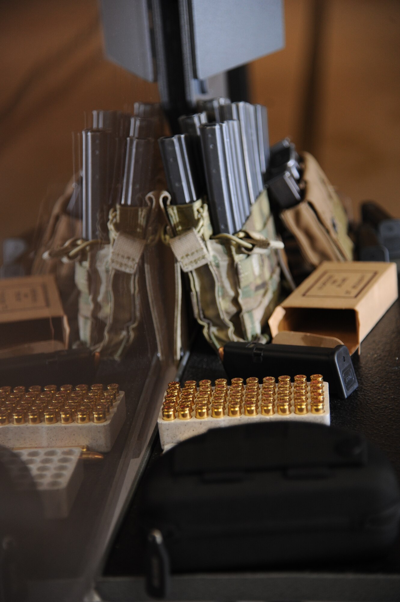Pistol ammunition and magazines sit on display for members of the 81st Security Forces Squadron to be used during a pistol competition hosted by the81st SFS May 13, 2014, at the indoor firing range, Keesler Air Force Base, Miss.  The pistol competition was held during National Police Week, which recognizes the service of men and women who put their lives at risk every day. (U.S. Air Force photo by Kemberly Groue)
