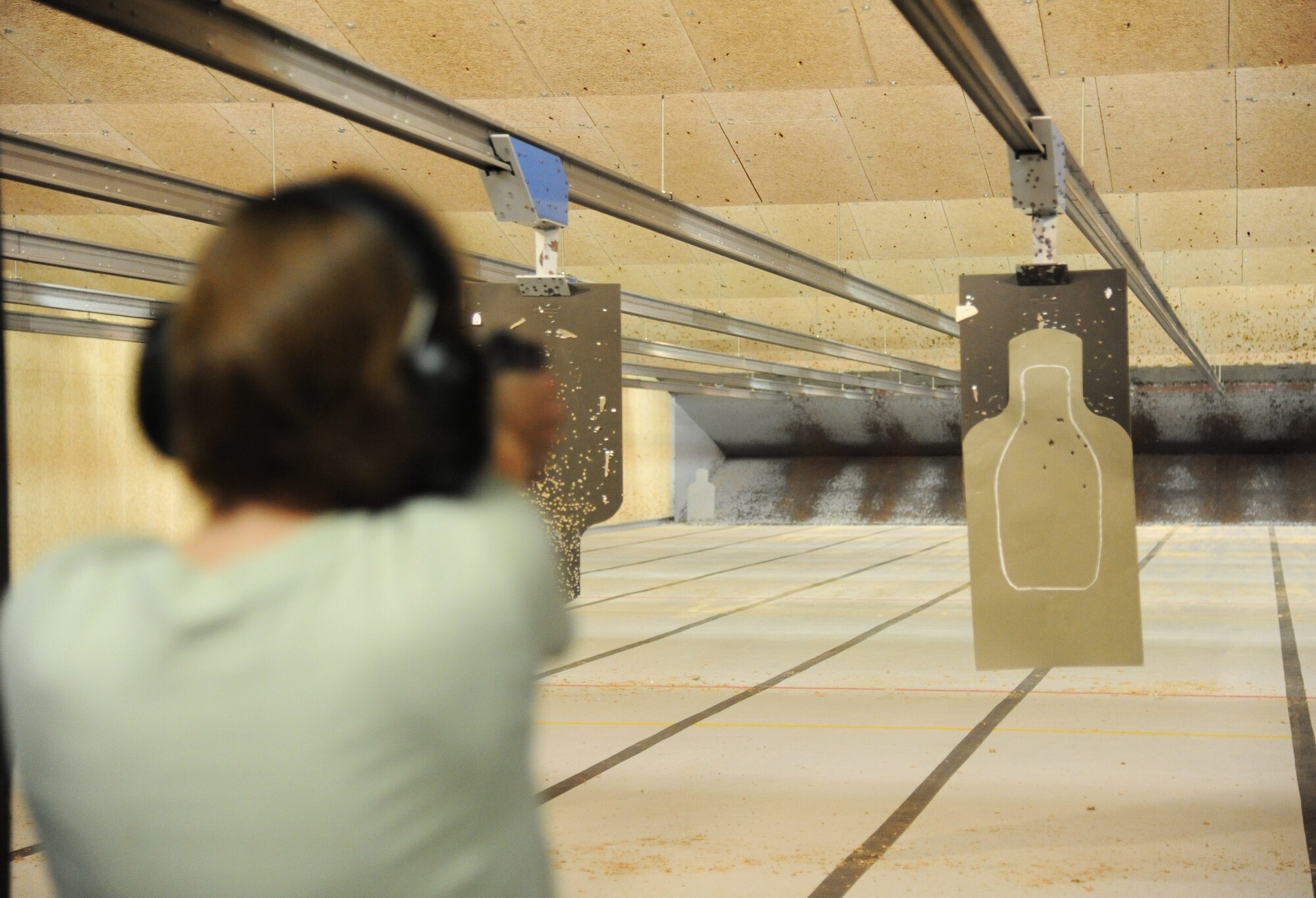 Master Sgt. Casy Boomershine, 81st Security Forces Squadron first sergeant, fires her pistol at a target during a pistol competition hosted by the 81st SFS May 13, 2014, at the indoor firing range, Keesler Air Force Base, Miss. The pistol competition was held during National Police Week, which recognizes the service of men and women who put their lives at risk every day. (U.S. Air Force photo by Kemberly Groue)